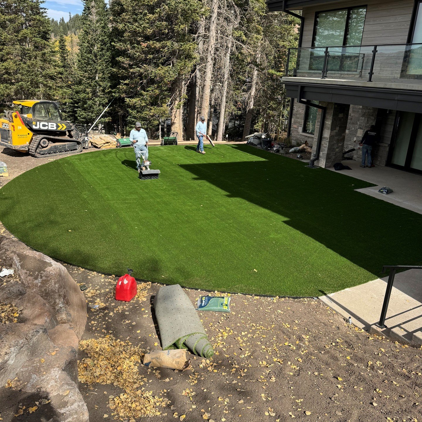Here's a work in progress photo of our skilled crew installing synthetic turf in our customer's back yard in Park City. High quality synthetic turf looks great year round, is very low maintenance, and, with our professional installation, can last for