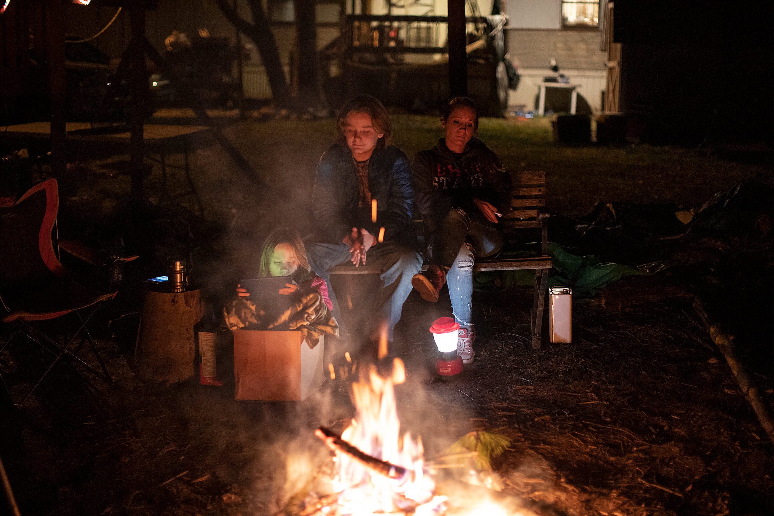  Lindsey Doughty sits with her son, Aiden, and daughter, Grace, outside by a campfire after Thanksgiving dinner at their home in Corning, Ohio, on November 28, 2019. Doughty finds more comfort having a quiet celebration with her two children than dea