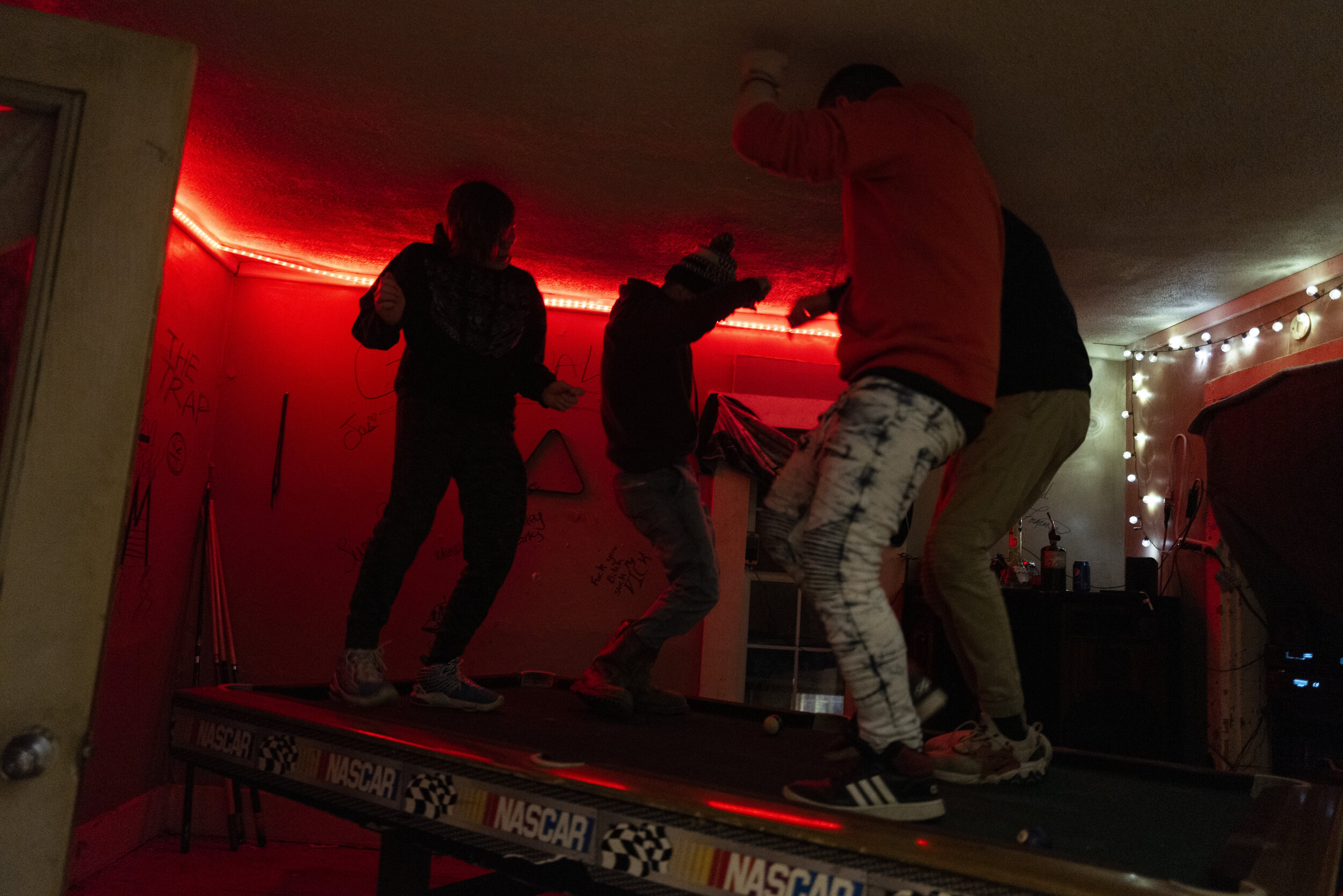 Reuben dances on a pool table with his friends in their “trap house” in Corning, Ohio, on March 16, 2021. “I came here to enjoy my childhood that I didn't get. I’m almost 18 now. So, this is the little bit of time that I have to be a child, and I'm 