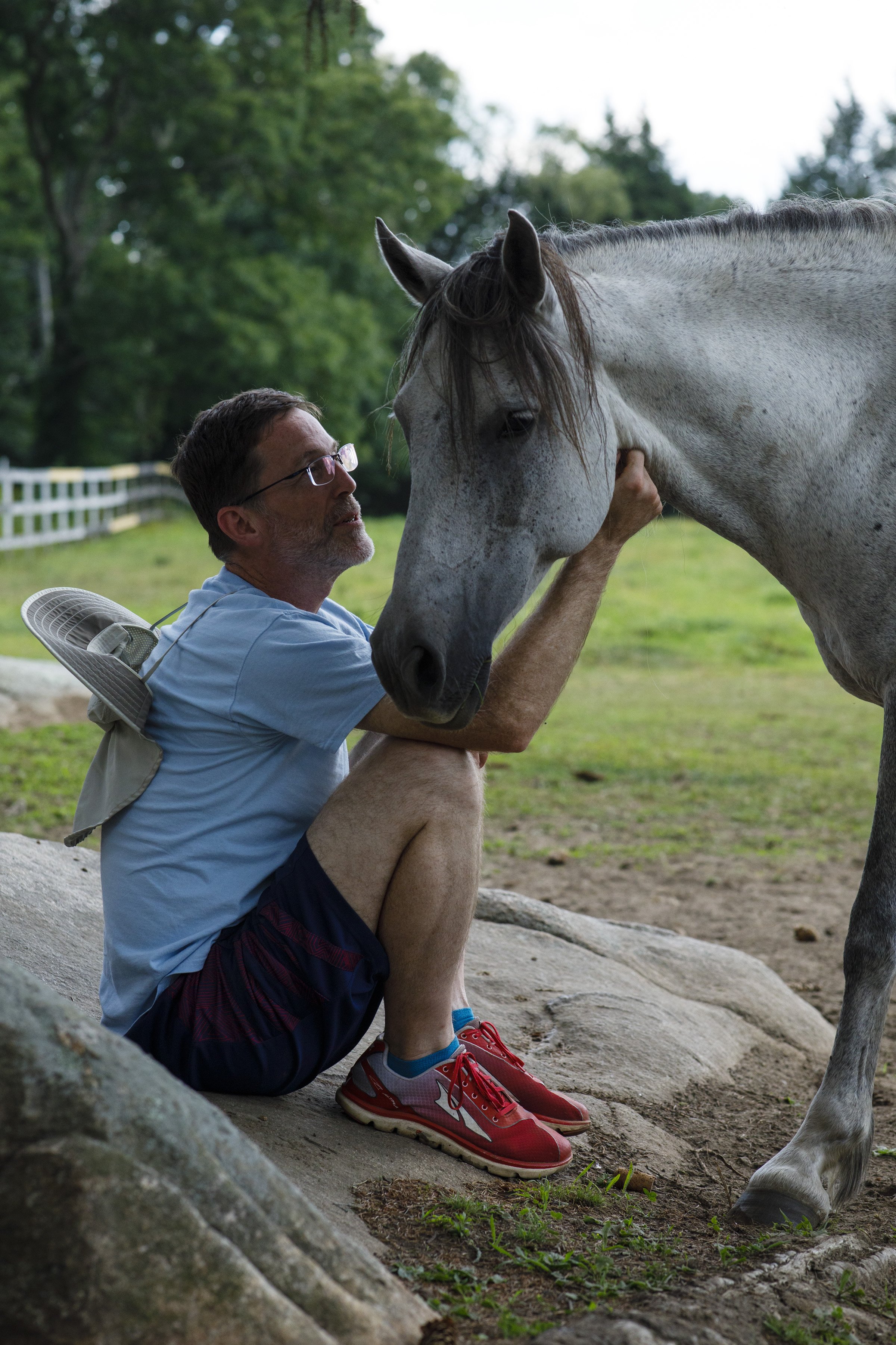  US Army Space Command veteran Scott Cousland scratches MoonShadow, a horse that was rescued from a kill pen in Oklahoma, as she walks up to him at Project ComeBack in Holliston, Mass. on July 20, 2022. "I thought I had good bonding... ultimately eve