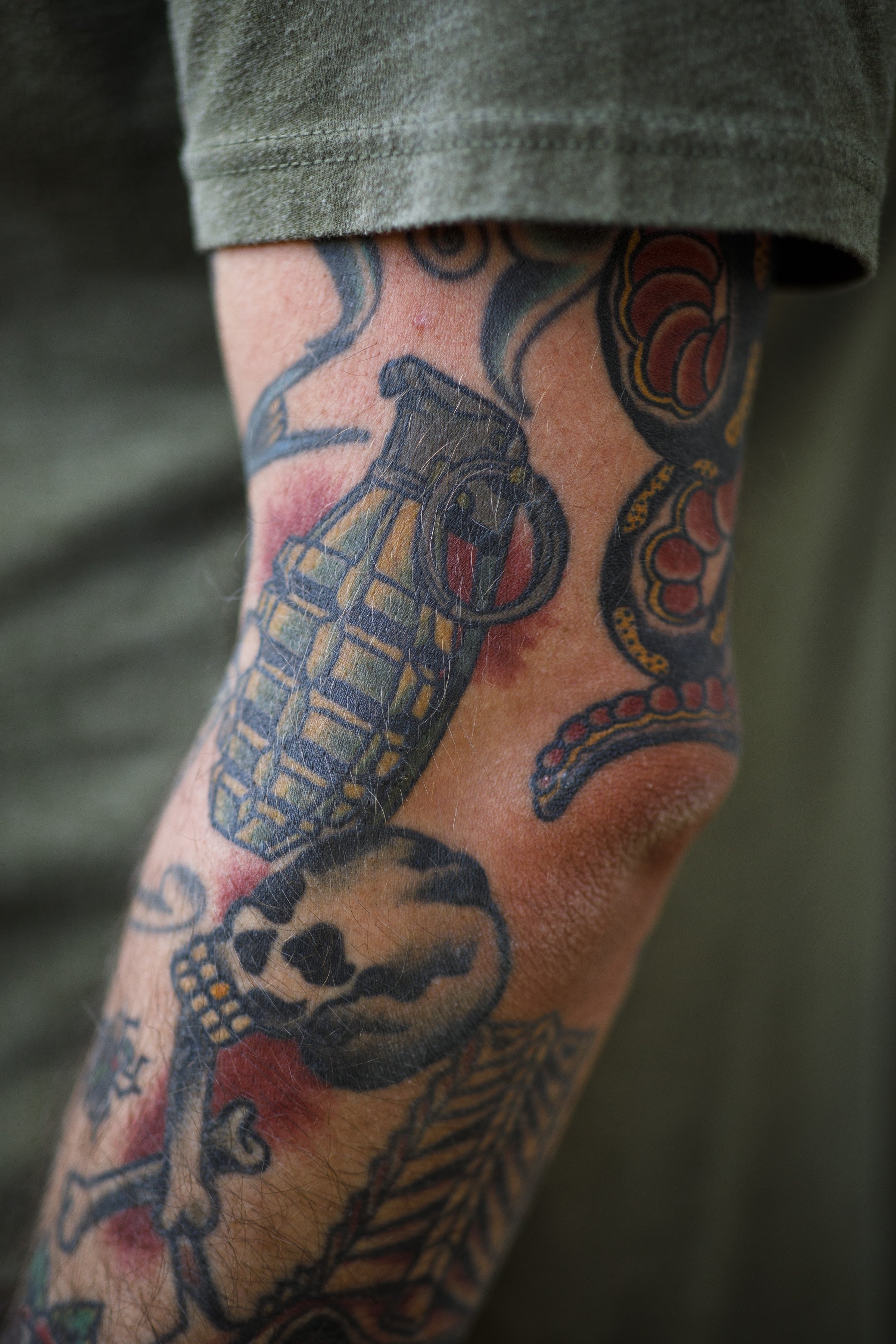  A grenade is tattooed on the arm of Derek Stirk, one of the veterans taking part in the six-week course at Project ComeBack in Holliston, Mass. on August 3, 2022. " It (service) was part of my life, but it's not what defines who I am now," says Stir