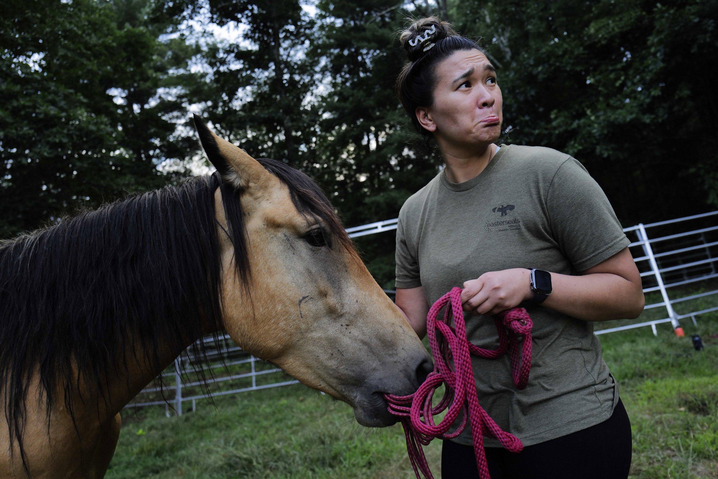  US Marines veteran Theresa Hughes bonds with her horse Kai, an American mustang found in a kill lot in Texas, after weeks of difficulty approaching the horse at Project ComeBack in Holliston, Mass. on August 10, 2022. 