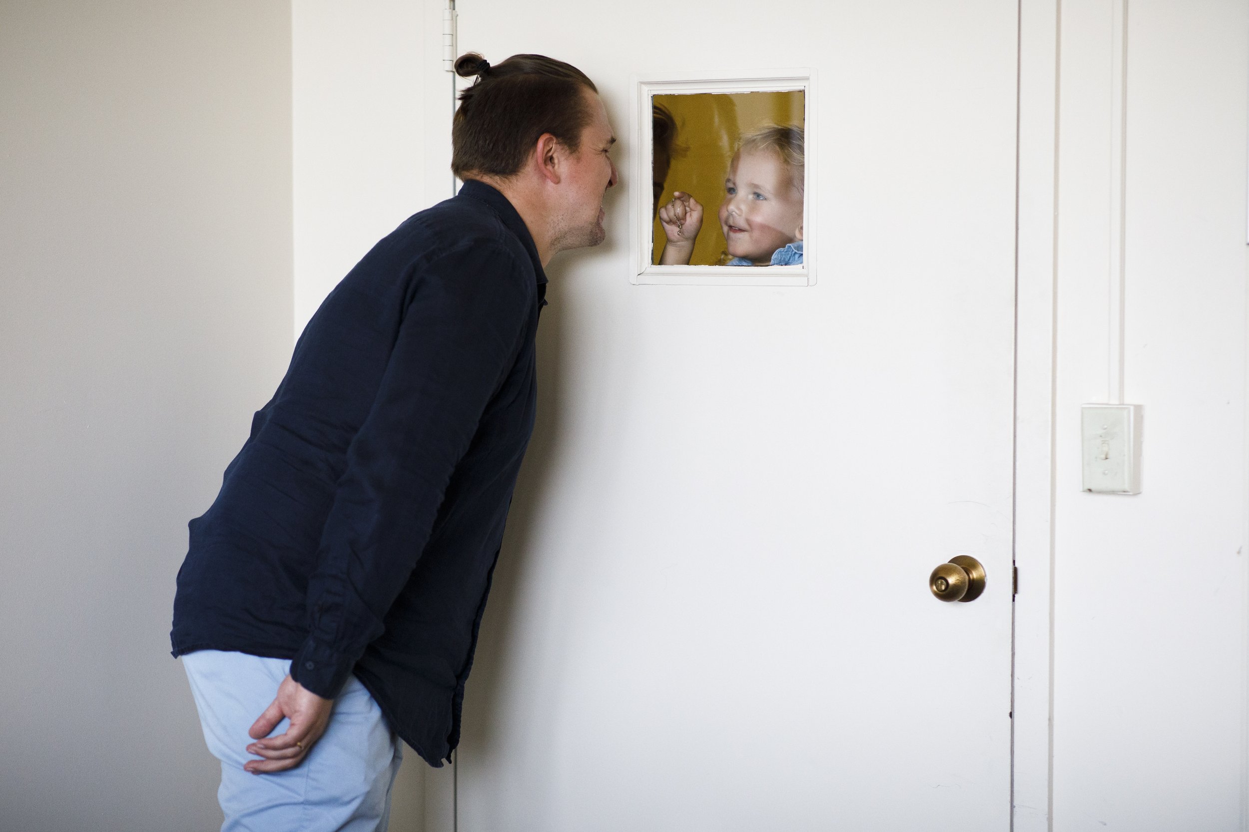  Belarusian opera singer Ilya Silchukou looks at his son Lawren, 3, through a window during a rehearsal at Boston University’s College of Fine Arts on September 10, 2022.  Silchukou was fired from his job back home and had to flee the country when he