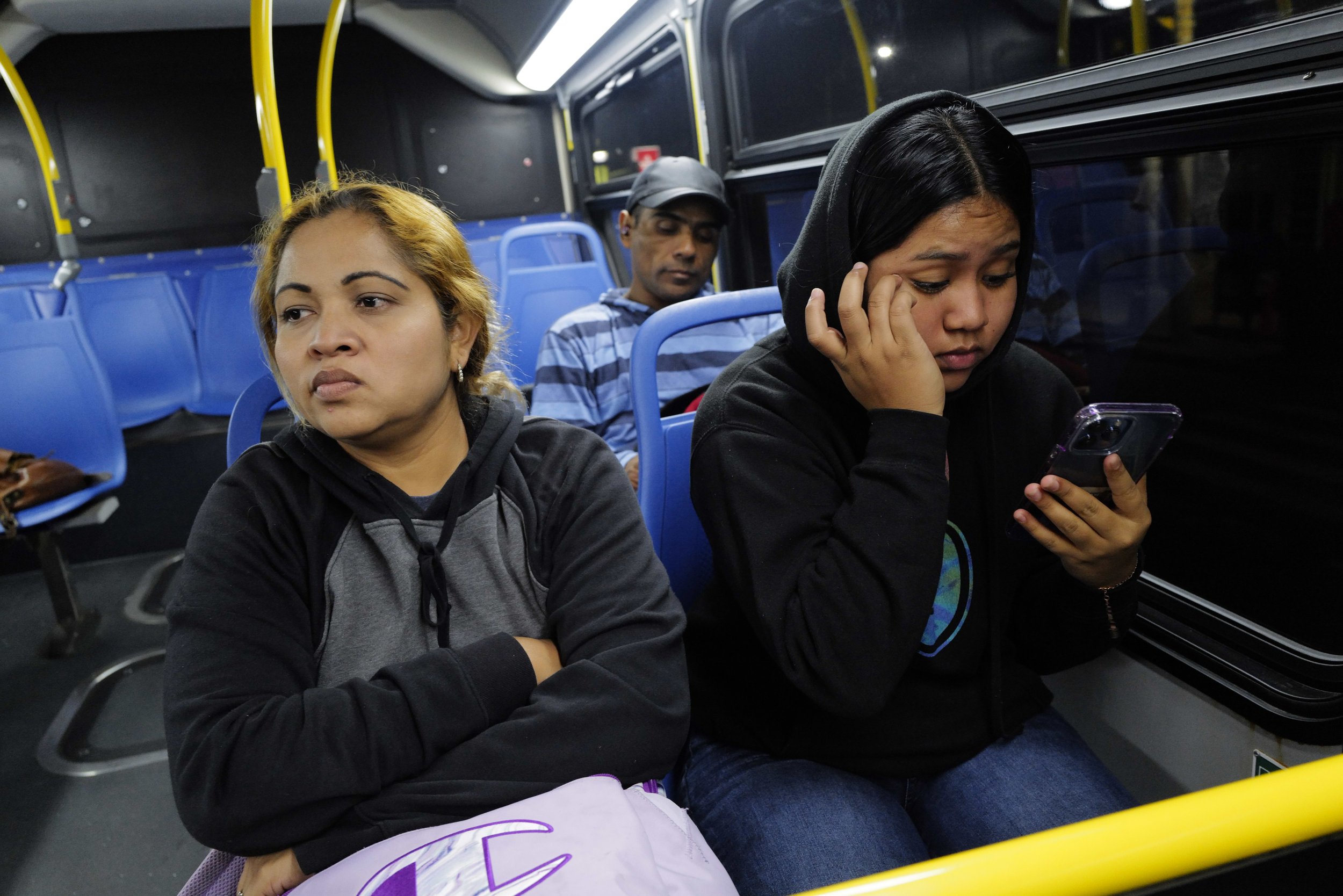  Teresa, her daughter Kairy Lisbeth, 17, and Manuel ride the bus home after Teresa and Manuel finished work on Sept. 30, 2022.  
