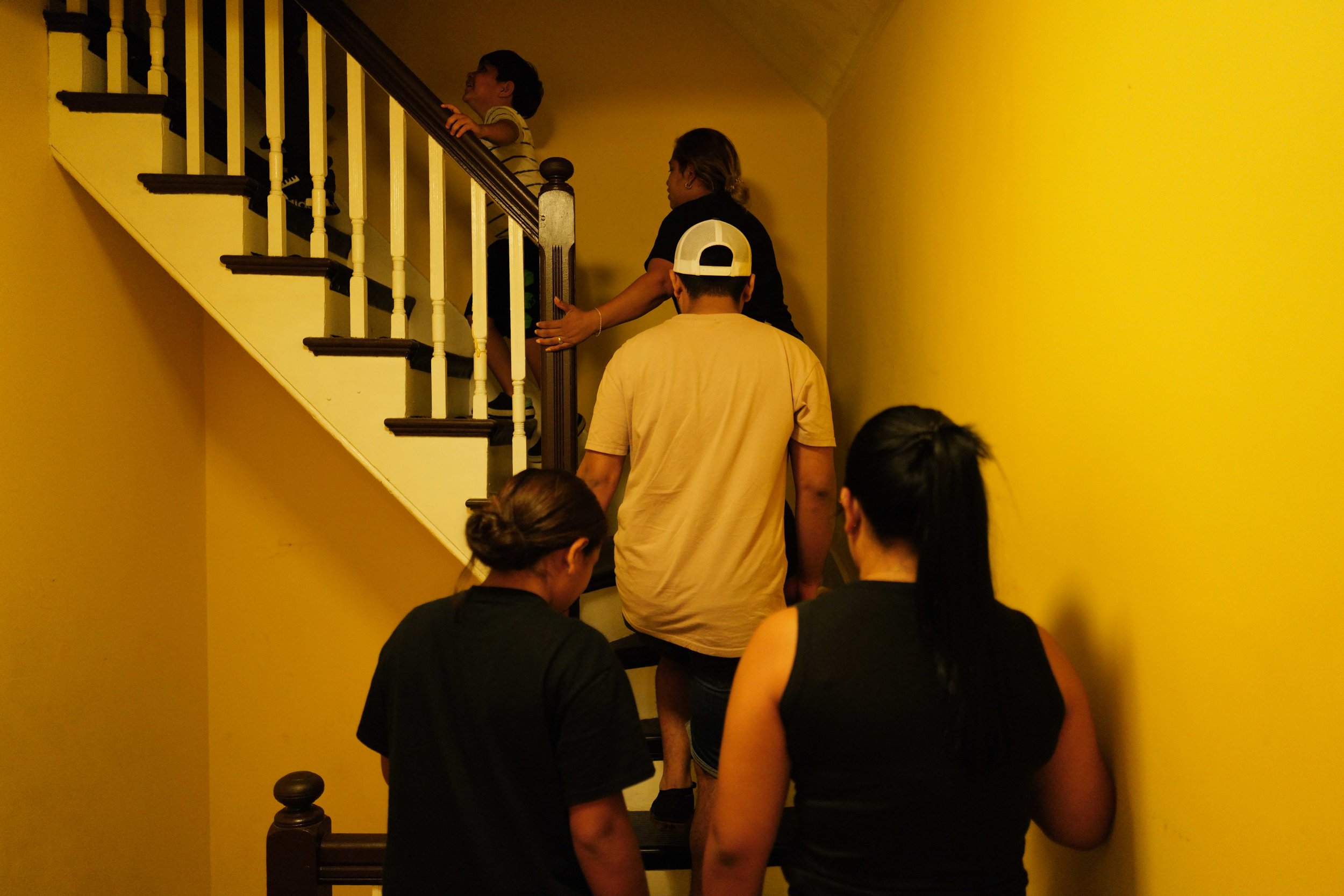  From top left) Raul Alexis, 6, Teresa, Melquencedec Anthony, Fernanda Aimee, 12, and Kairy Lisbeth, 17, walk up the stairs to their new home right before midnight in Somerville, Mass. on Sept. 1, 2022. 
