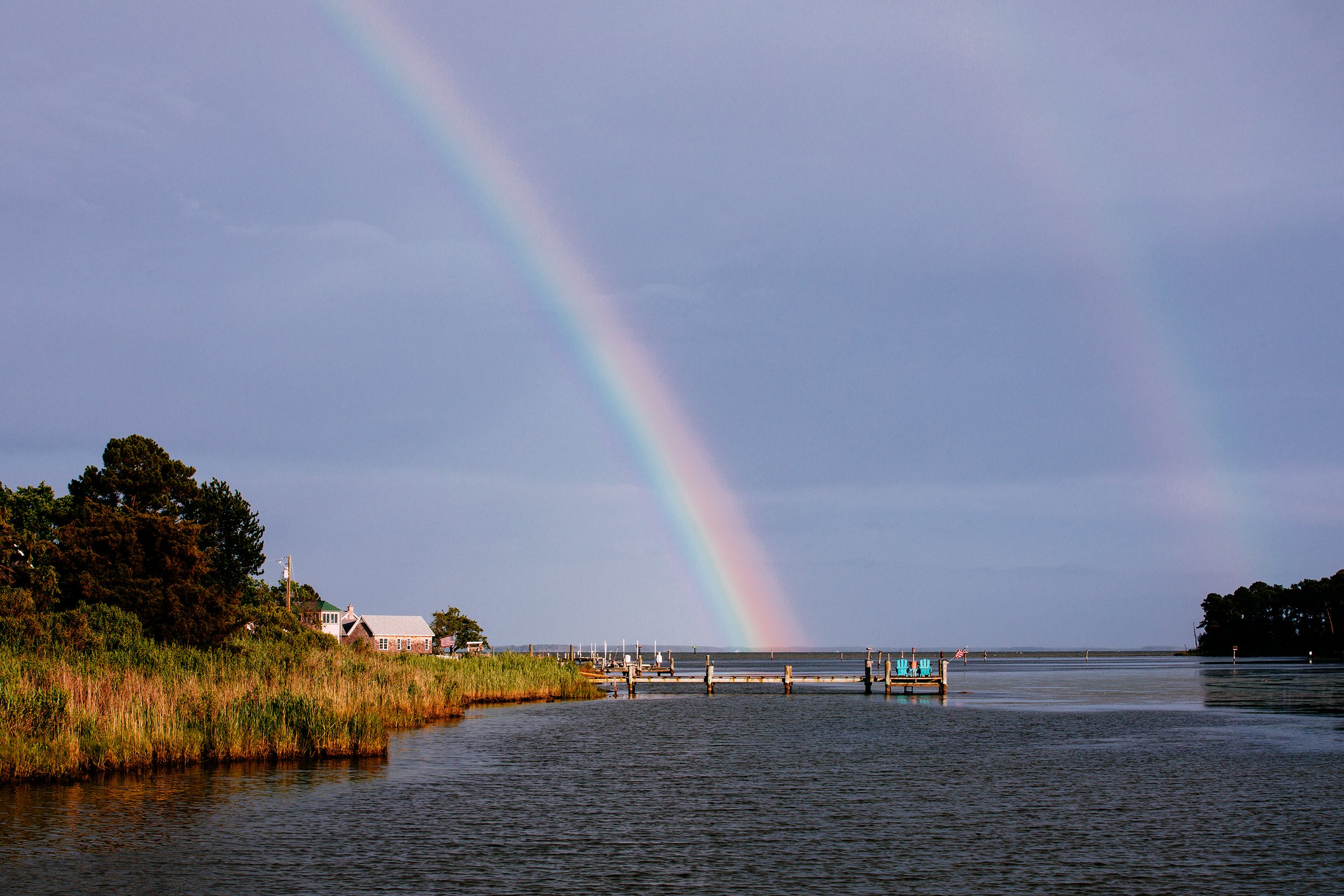  A double rainbow appears after a cloudburst passed over Tilghman Island. Areas like Tilghman Island are still home to smaller traditional waterman communities, but have also been subject to gentrification and an increase in summer homes. 
