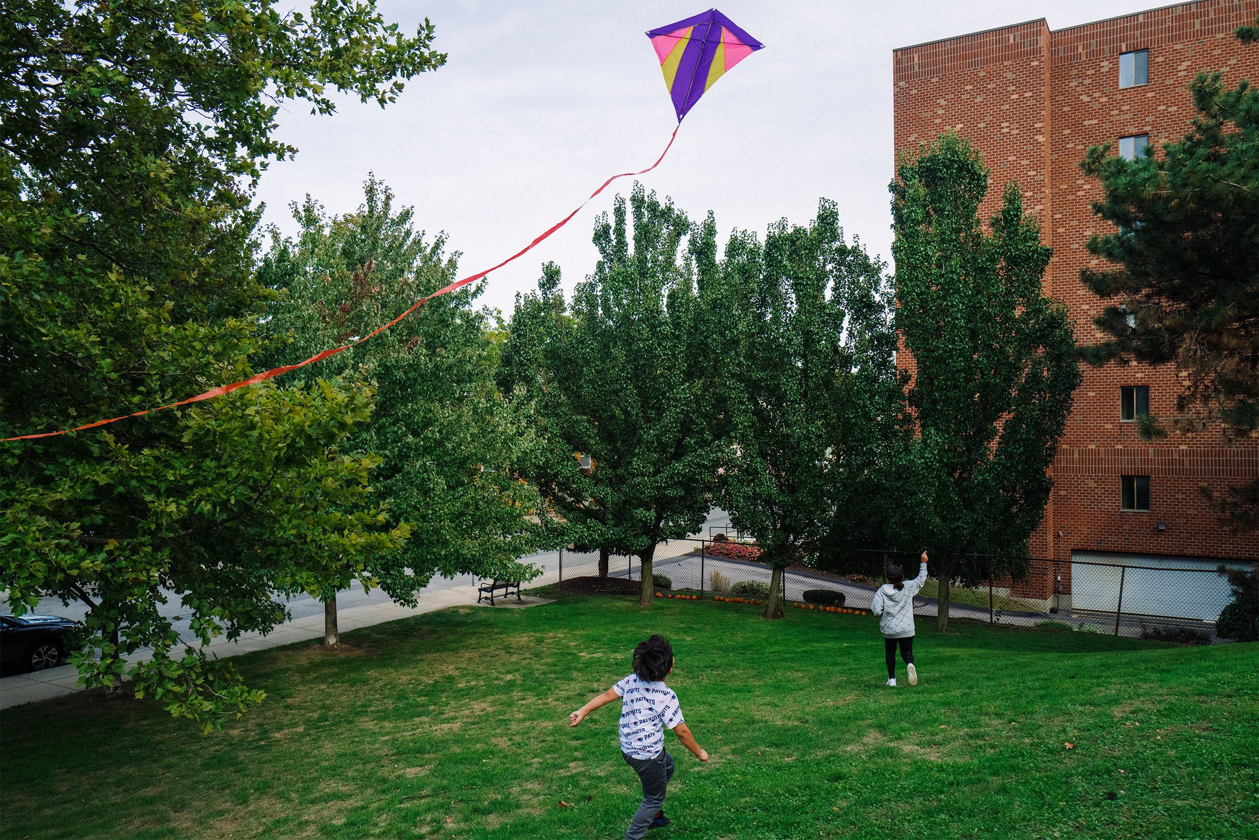  Teresa’s son Raul Alexis, 6, and Manuel’s daughter, 12, fly a kite at the park near their new home in Somerville, Mass. on Sept. 3, 2022. 