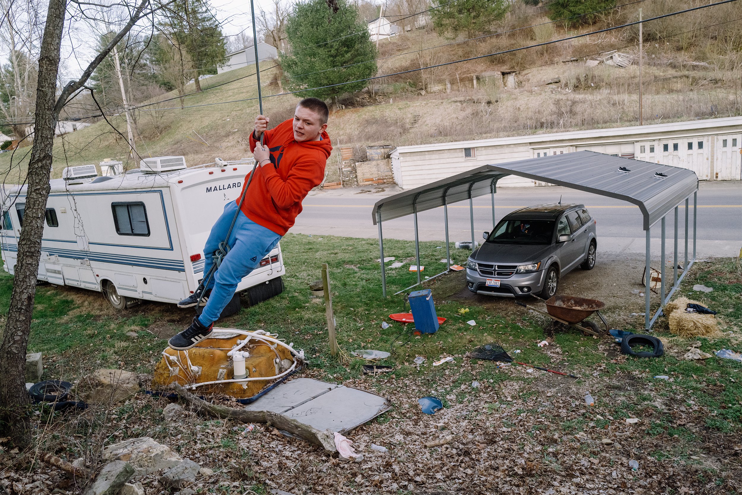  Reuben Kellar swings on a rope outside of Ben’s house in New Straitsville, Ohio, where he has been staying since January 2021 under his care on March 13, 2021. Having moved houses from his now deceased mother, grandparents and multiple foster famili