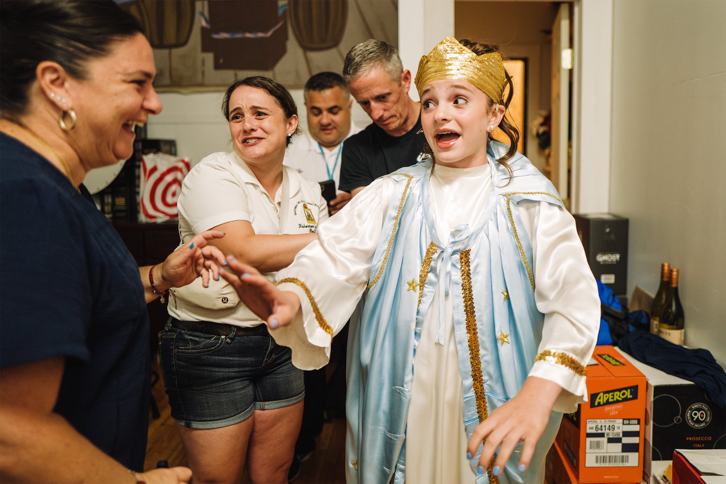  Gianna Puccio, 12, is teased by her mom, Lina Puccio (left)  while preparing to fly as the angel for the second year in a row at the Feast of the Fisherman in the North End of Boston, Mass. on Aug. 20, 2023.  