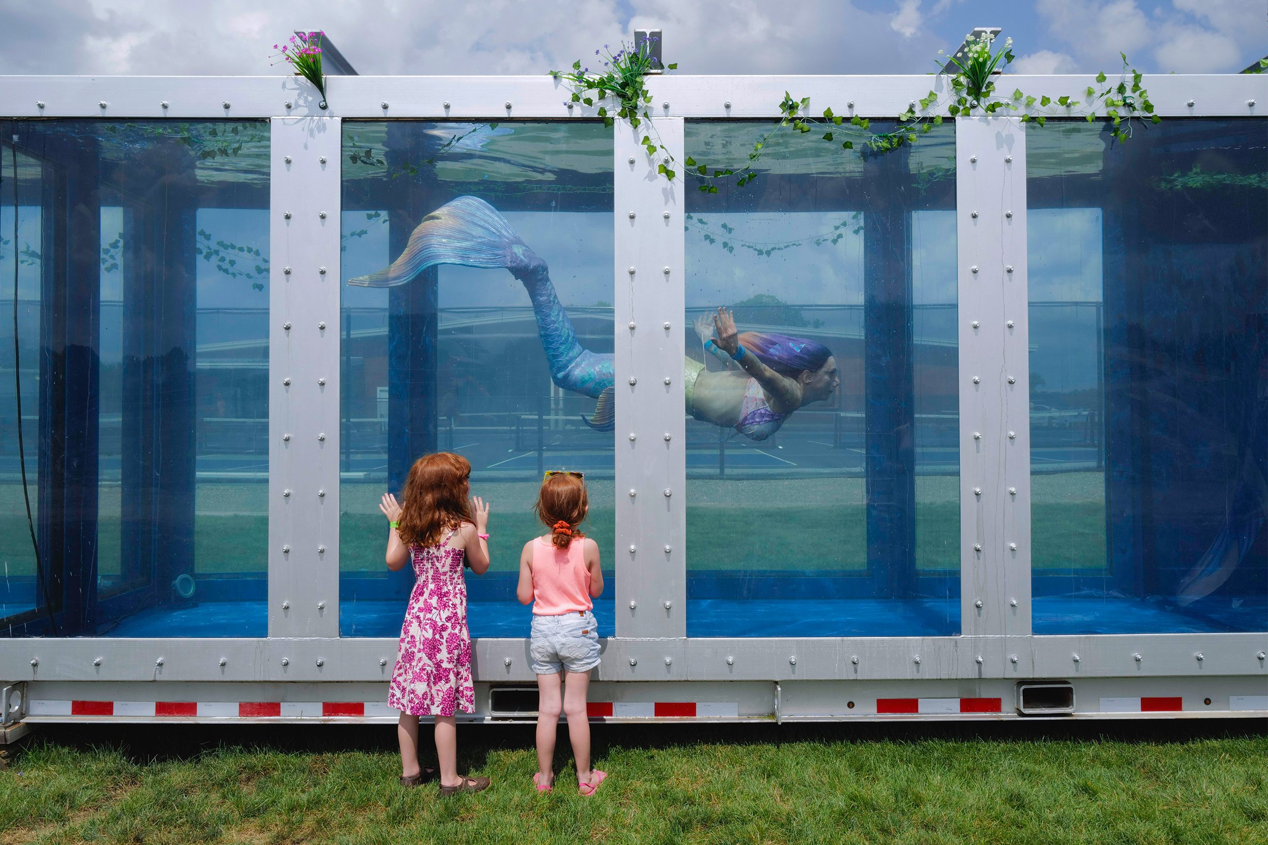  Brinnleigh Payne, 6, and Olivia Payne, 4, watch as the mermaid Seirios Moon swims across the nation’s largest mermaid tank at MerFest International 2021 in South Haven, Michigan on Friday, August 20, 2021. 