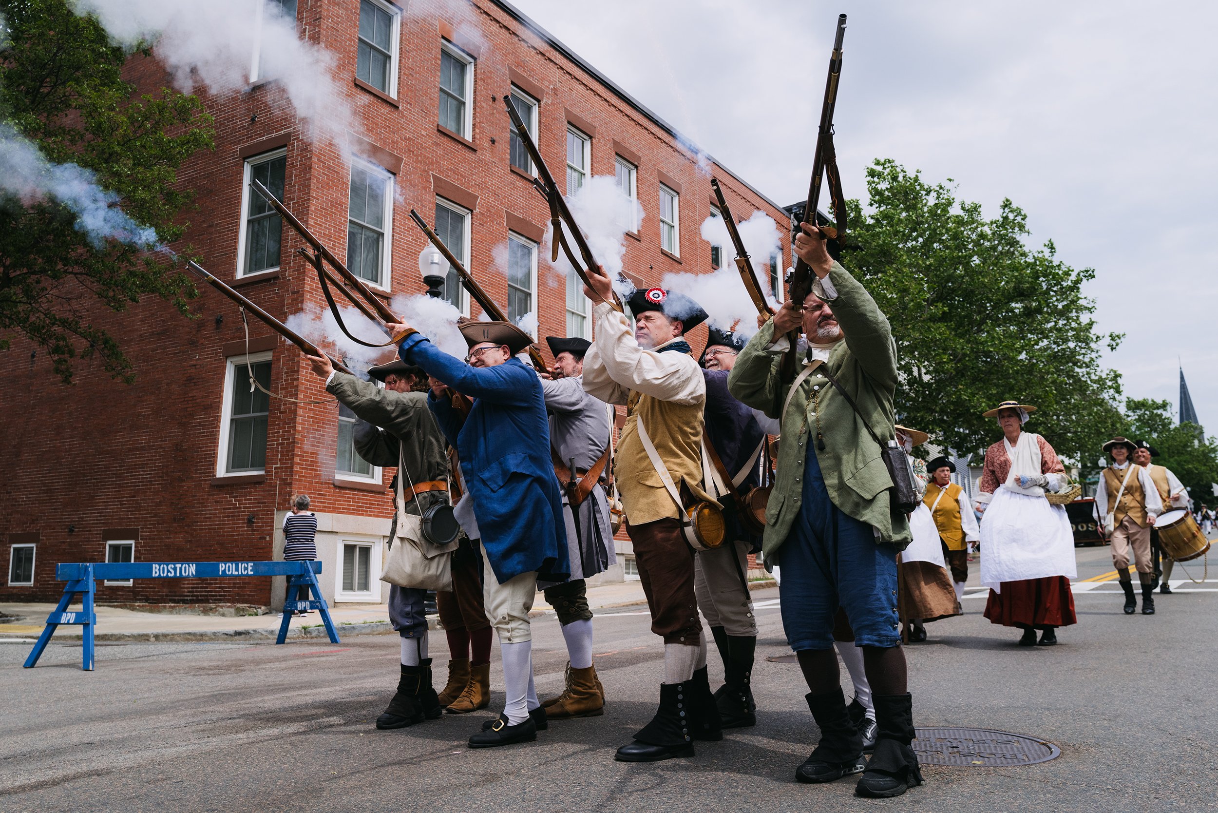  A Revolutionary War reenactment group fires muskets at the Bunker Hill Day Parade in Charlestown on June 12, 2022. 