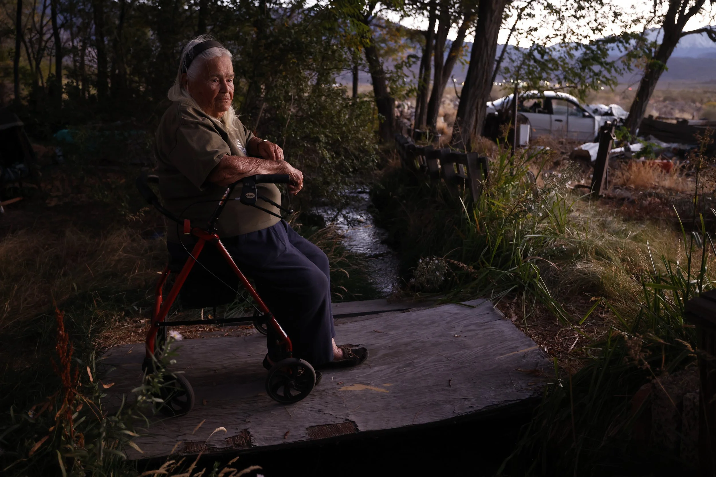  Jenny McKellips, 89, sits over a creek running though her home that she drinks out of every day in the Red Hill area of Owens Valley on Wednesday, Oct. 8, 2025 in Bishop, CA. McKellips has been fighting a land dispute against the DWP over her proper