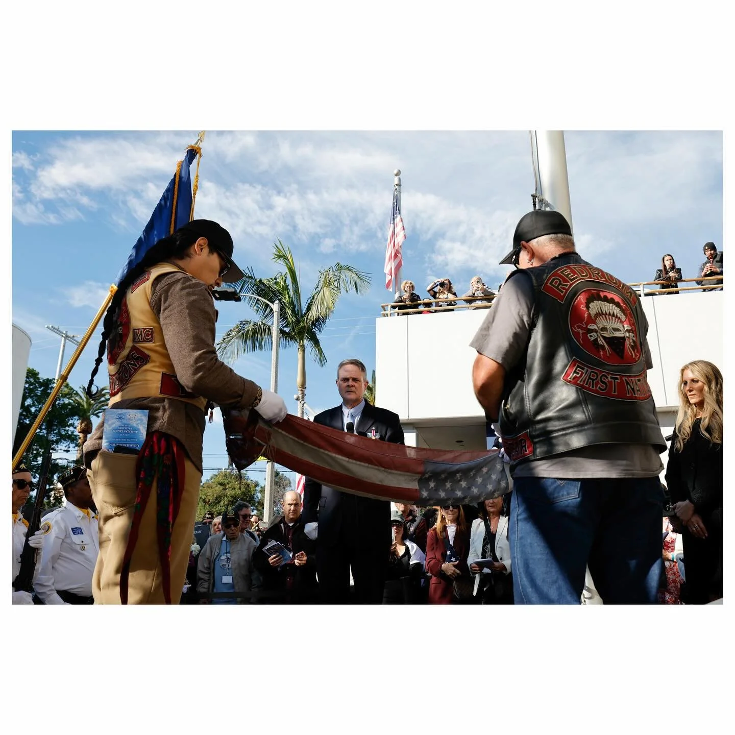 The American flag that stood throughout the Palisades fires at the American Legion is taken down during the white glove flag presentation and community-led remembrance ceremony at the American Legion Post 283. Families received flags honoring lost lo
