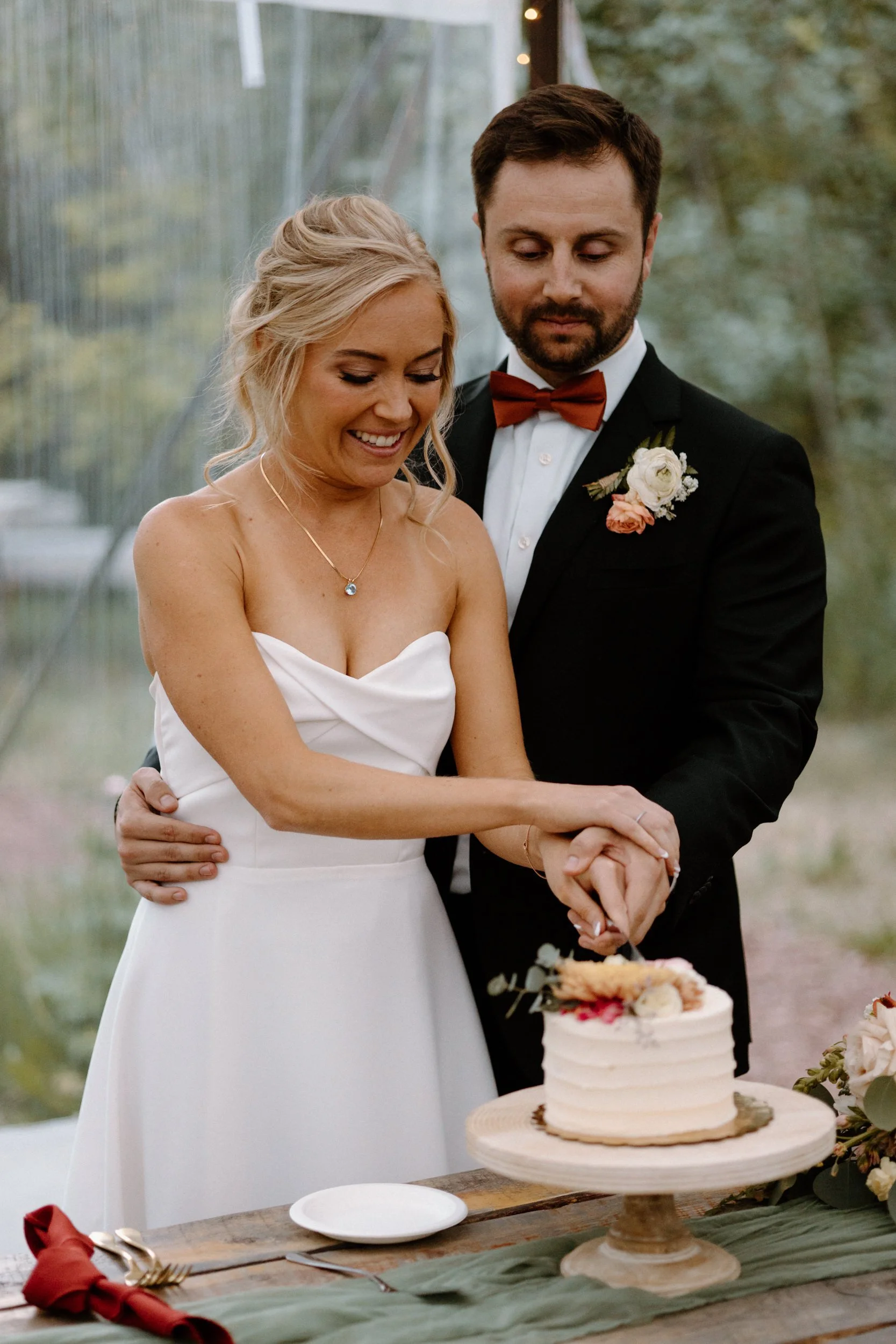 Bride and groom cutting cake on wedding day at Blackstone Rivers Ranch
