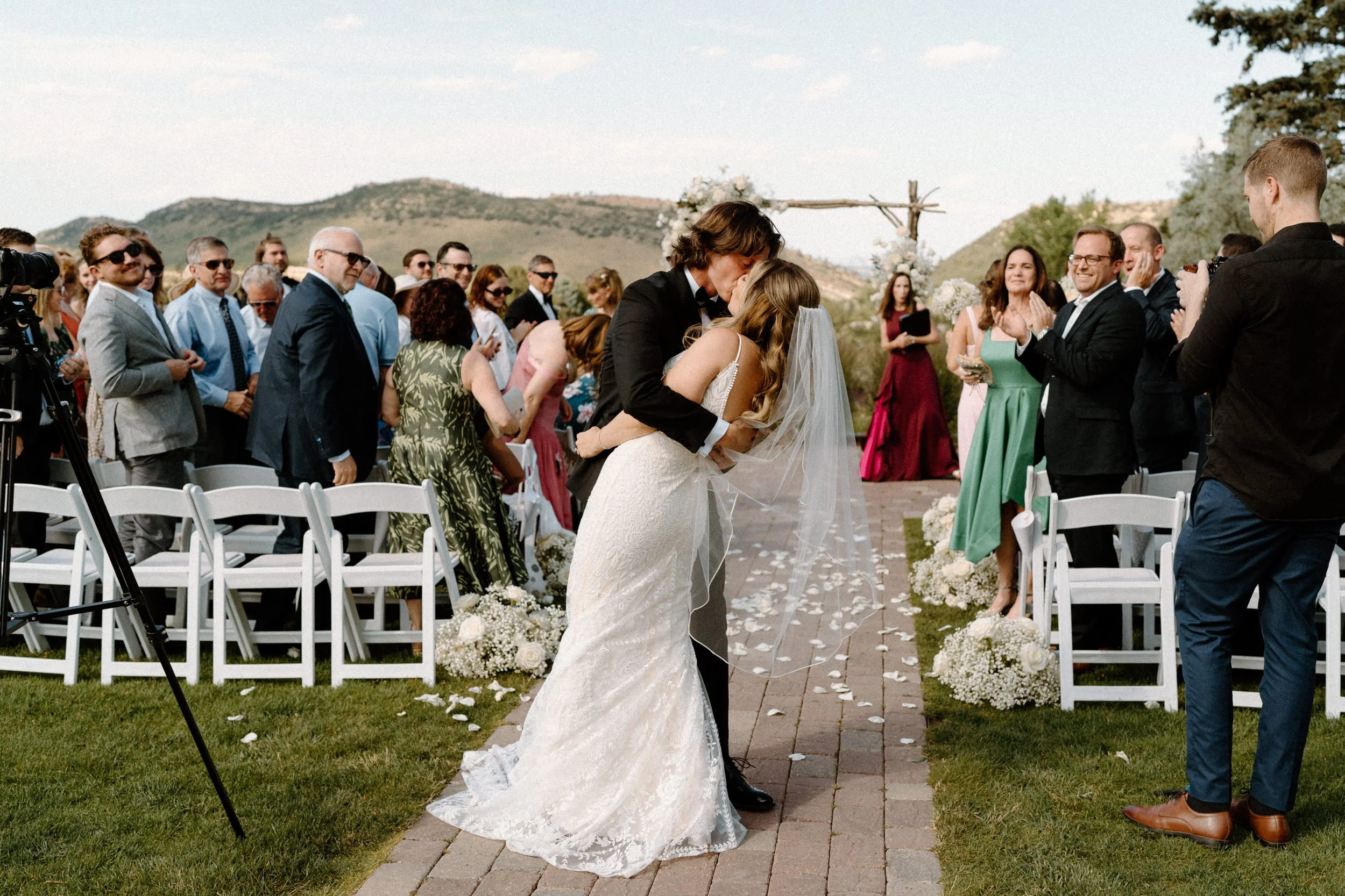 Bride and groom kissing at the end of the aisle after ceremony on wedding day at The Manor House