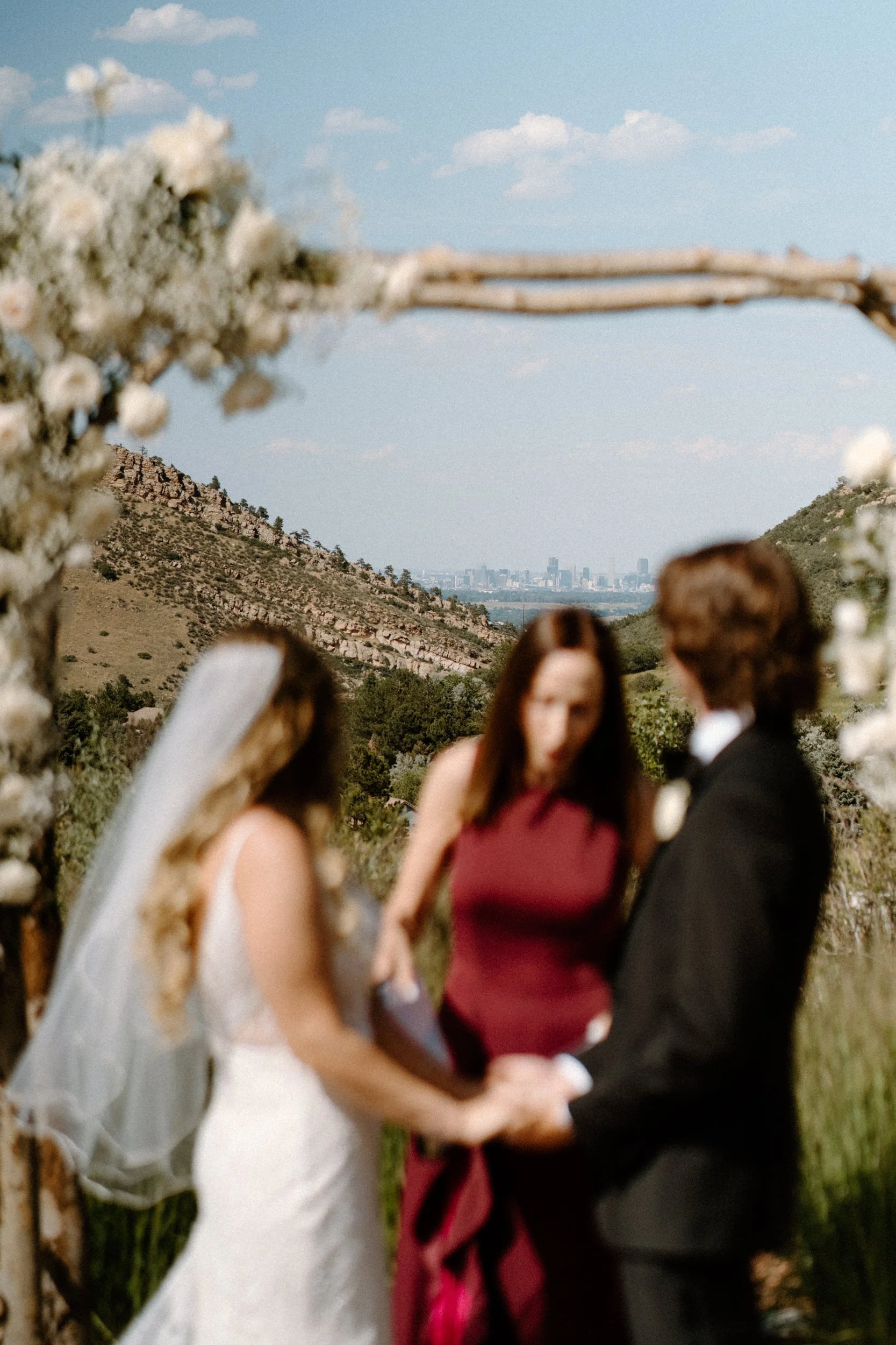 Ceremony focused on the Denver skyline from a wedding at The Manor House