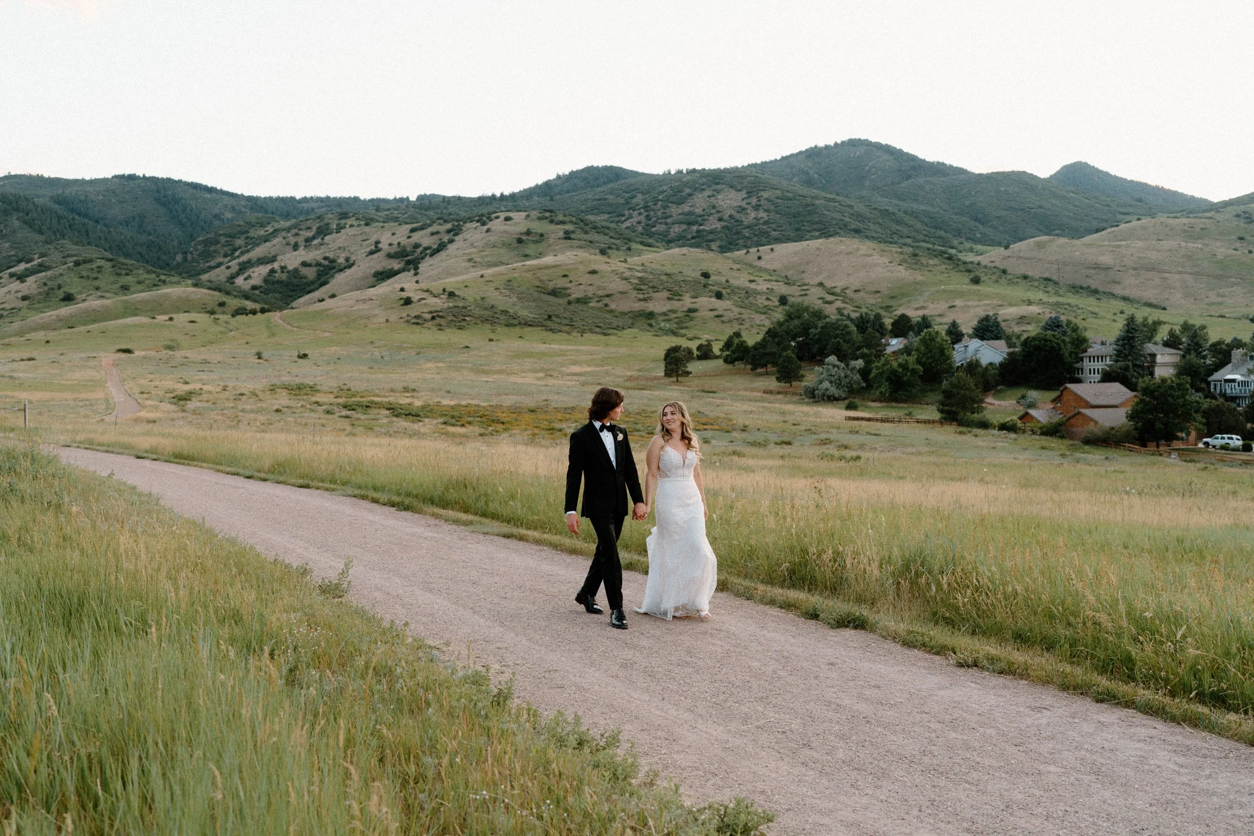 Bride and groom walking on a path on wedding day at The Manor House