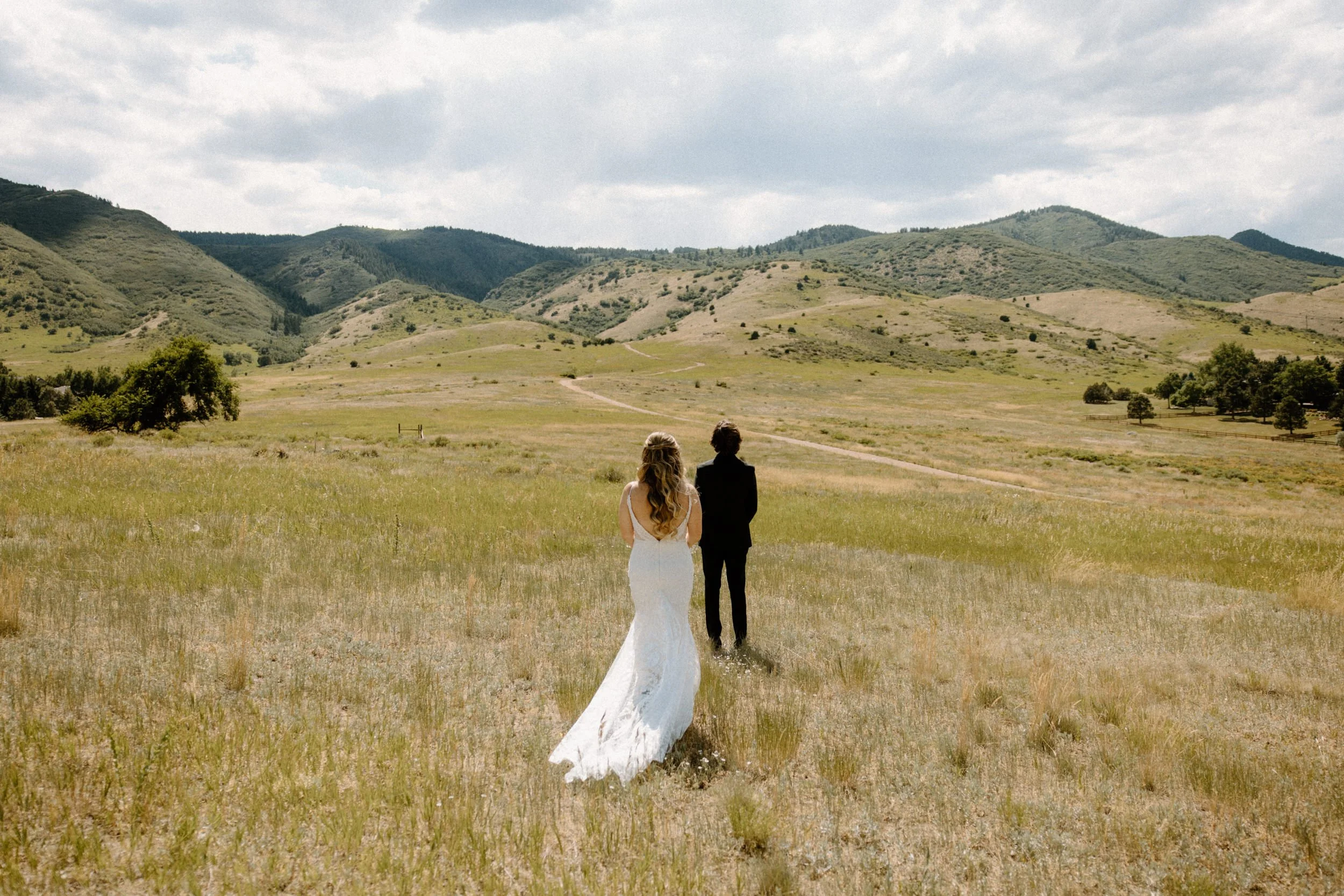 Bride walking towards groom for first look on wedding day at The Manor House