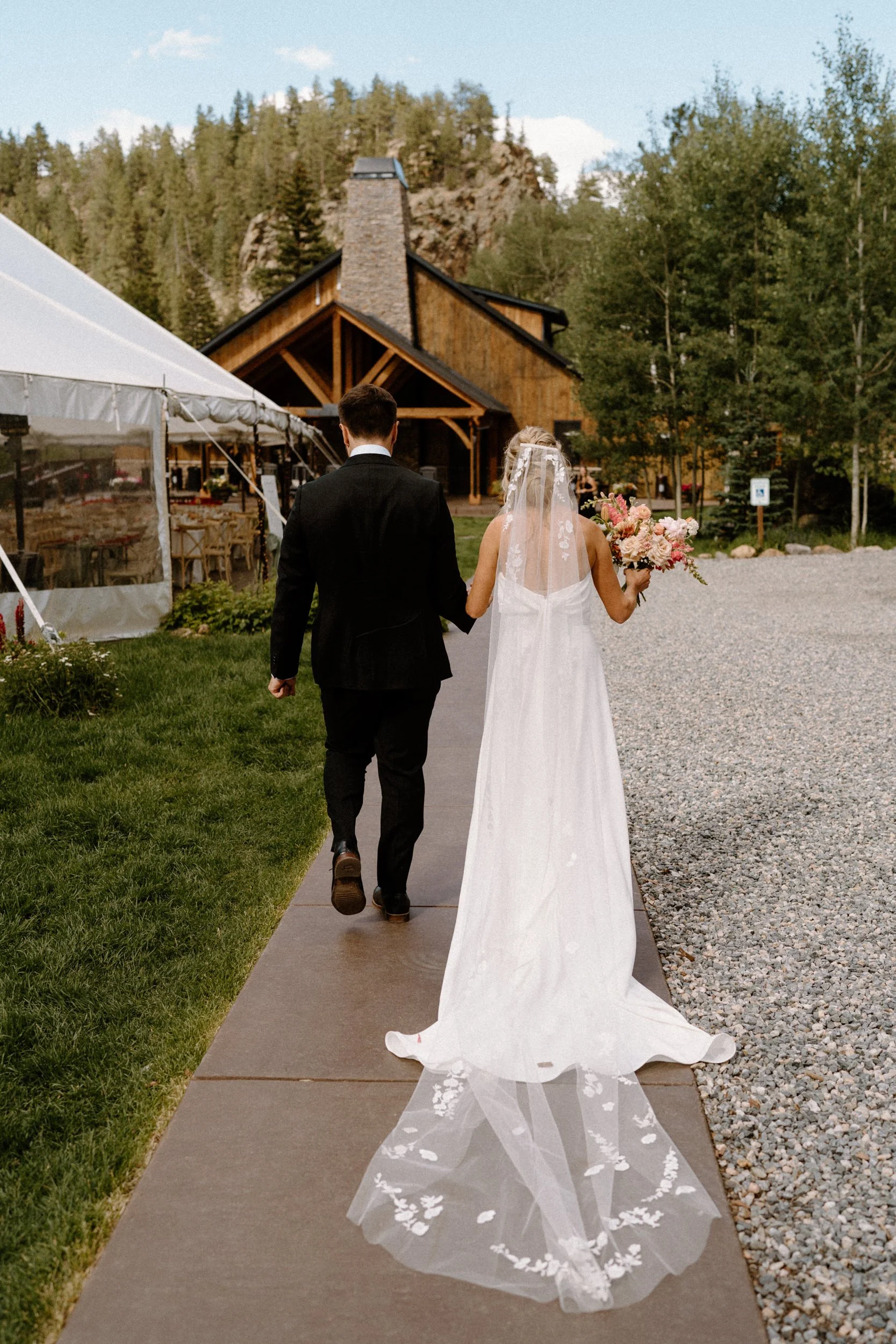 Bride and groom walking away from ceremony on wedding day at Blackstone Rivers Ranch
