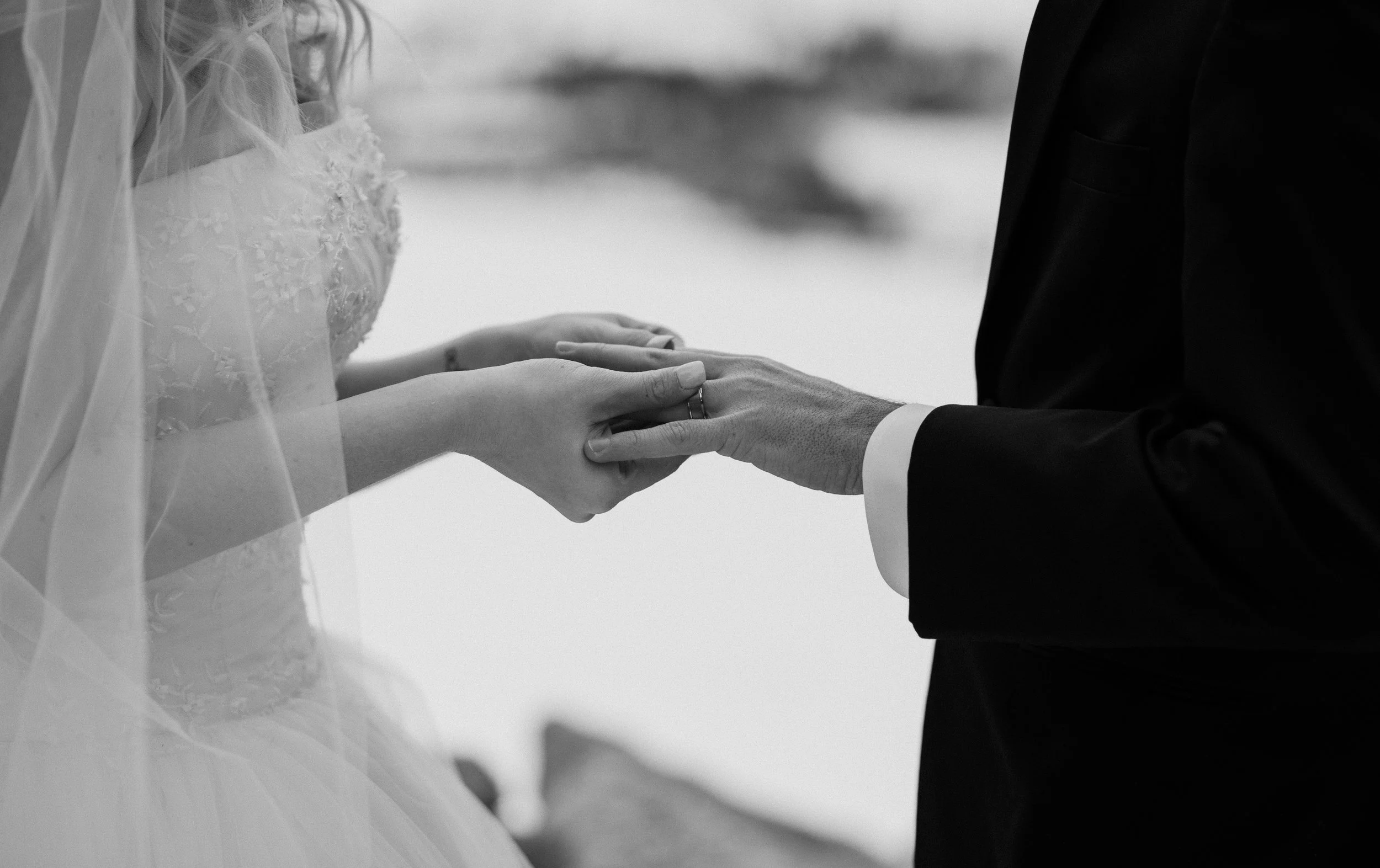 Sapphire Point winter adventure elopement in Colorado. Colorado elopement and wedding photographer took this shot of the bride putting on the groom's ring. 