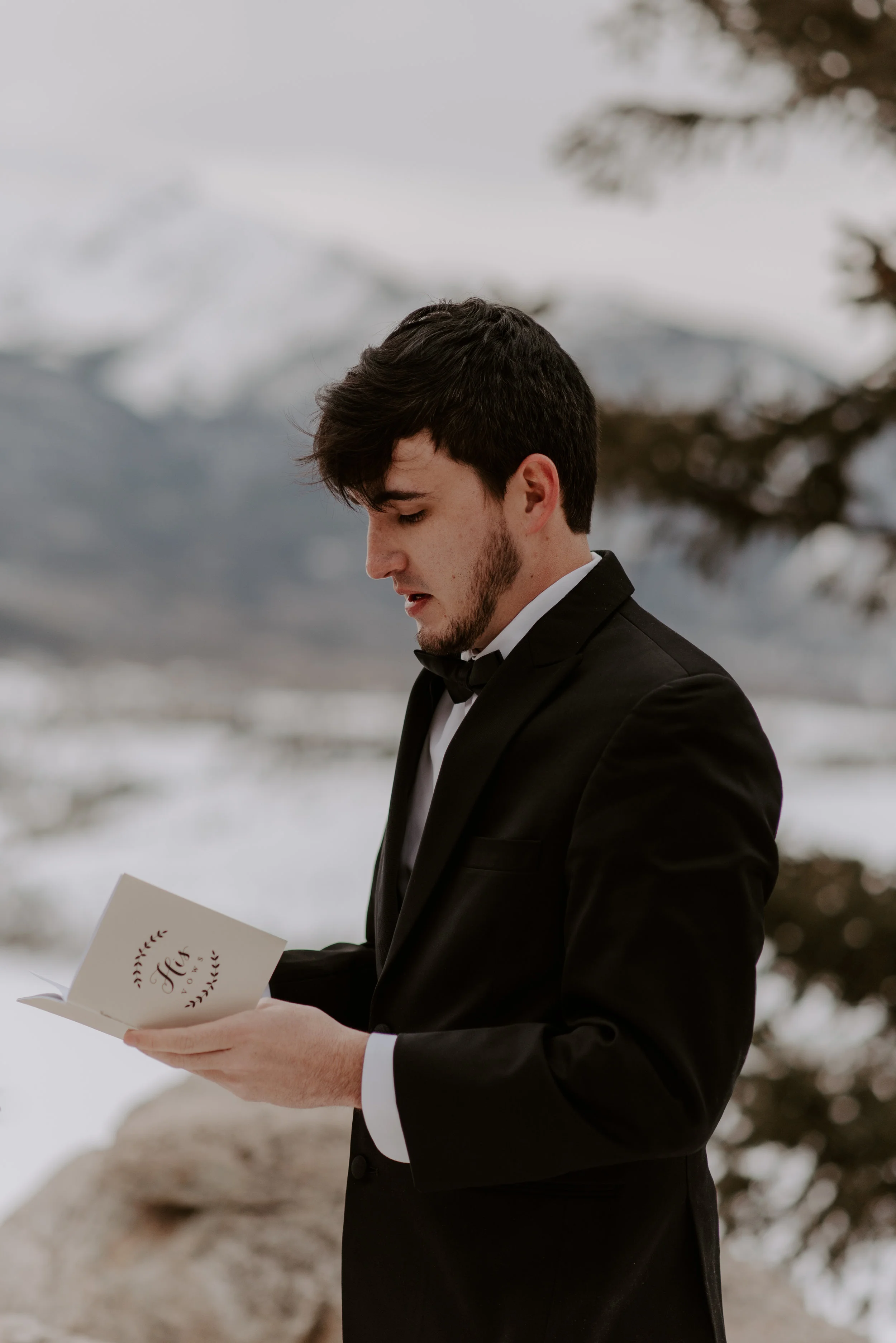  Groom reading his vows at a winter Sapphire Point elopement in Colorado. 
