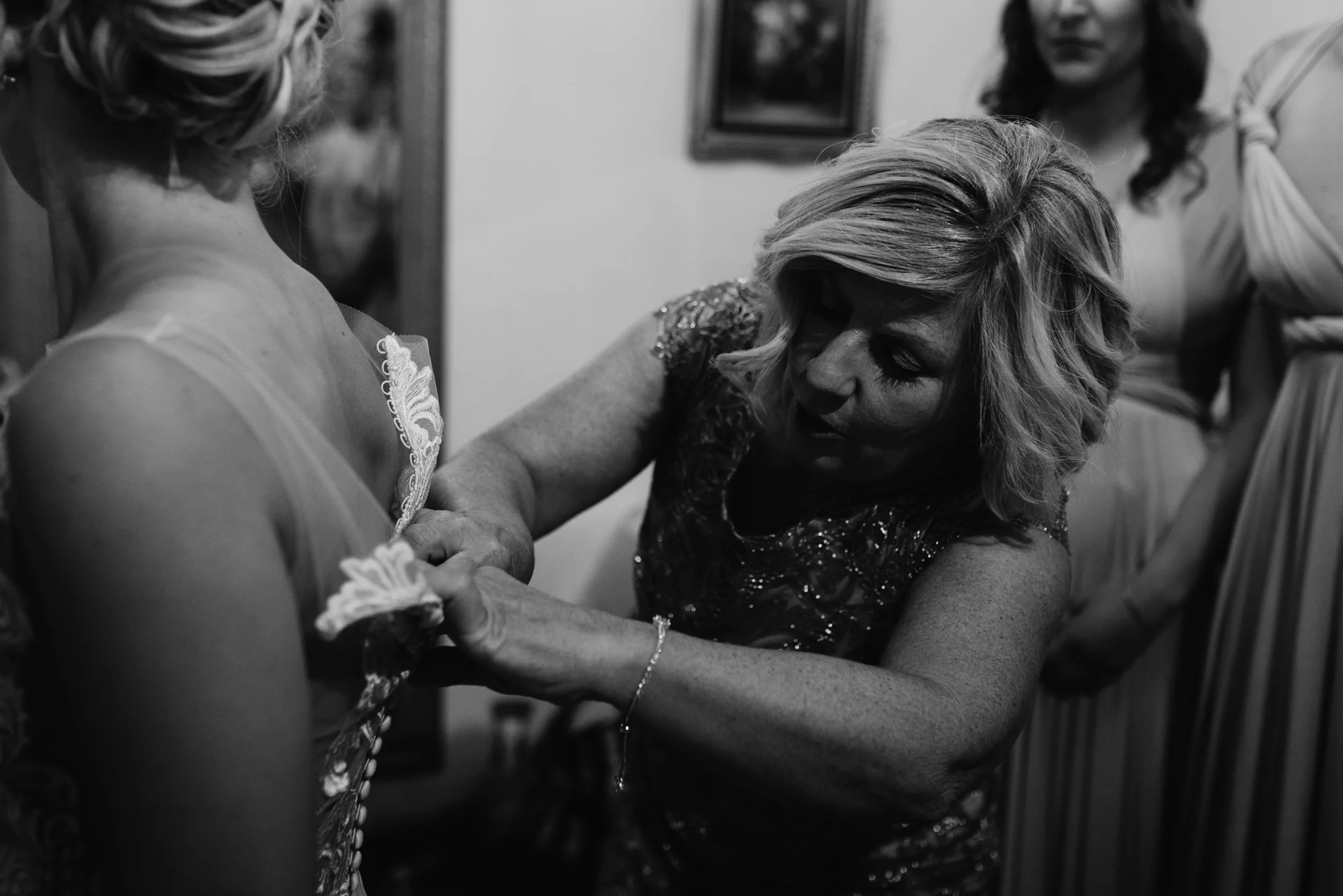  Downtown Denver wedding at Moss. Colorado wedding photographer. Mom helping put on dress. 