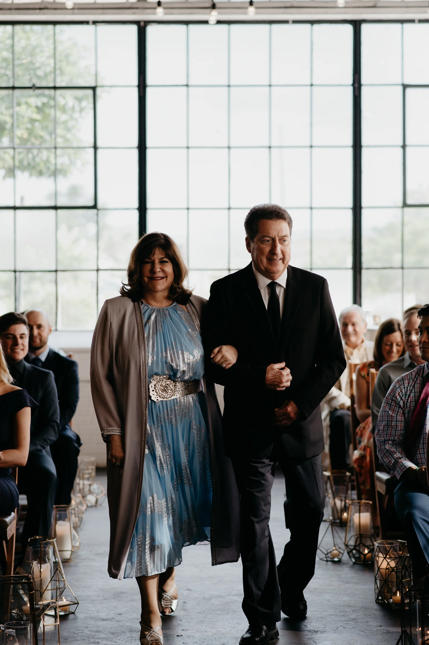  Mom and Dad walking down the isle at a Moss Denver wedding. Colorado wedding and elopement photographer. 