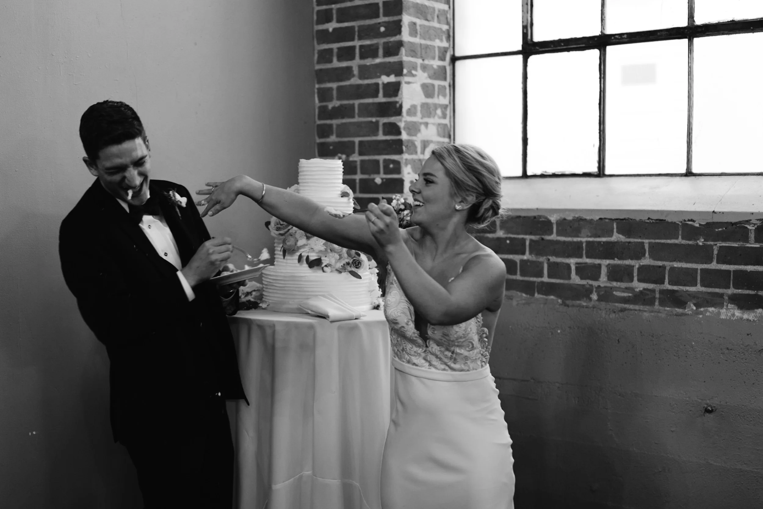  Moss Denver wedding. Bride and groom cake cutting. Colorado wedding photographer. 