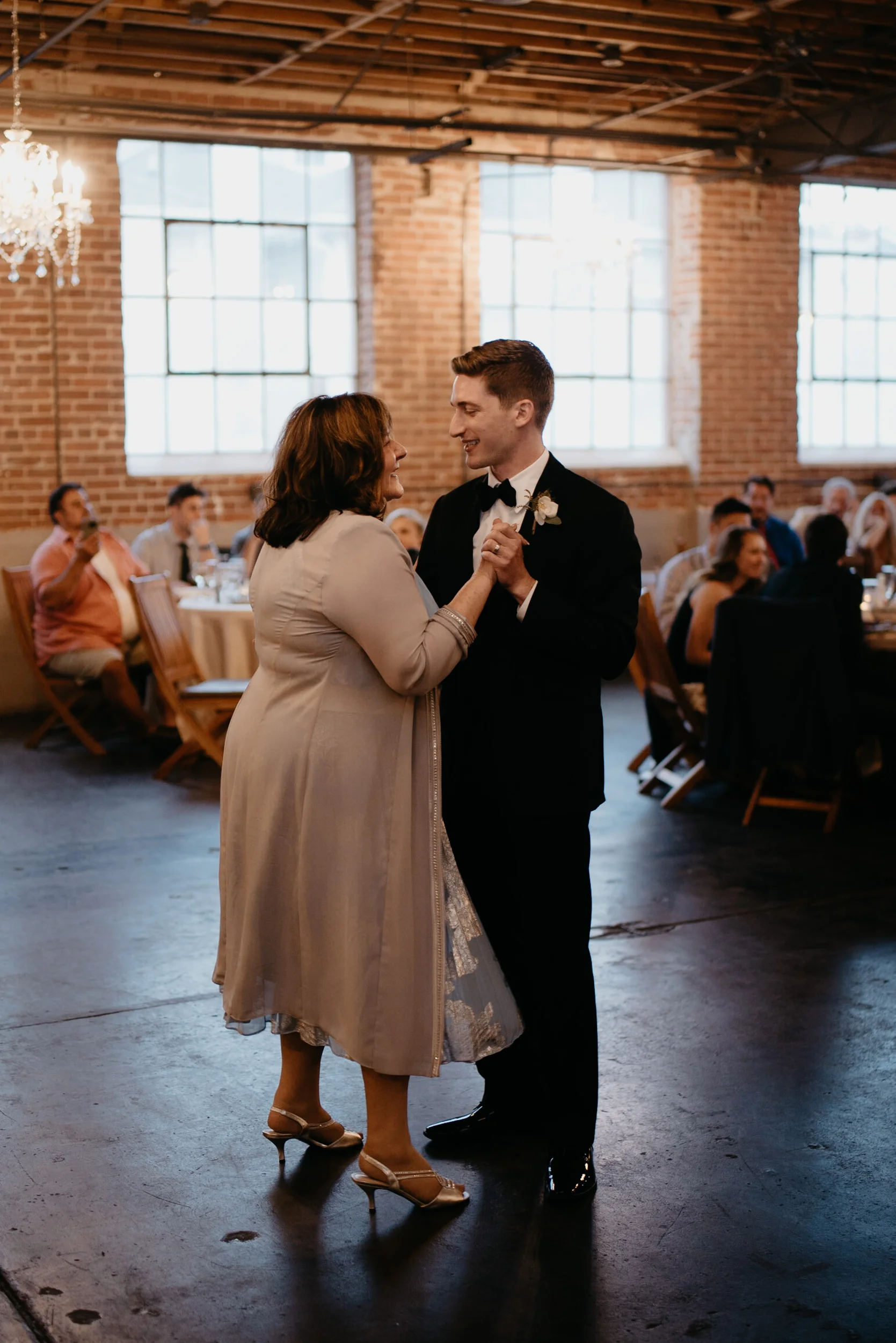  Denver city wedding at Moss. Mother and son dance. Colorado wedding photographer. 