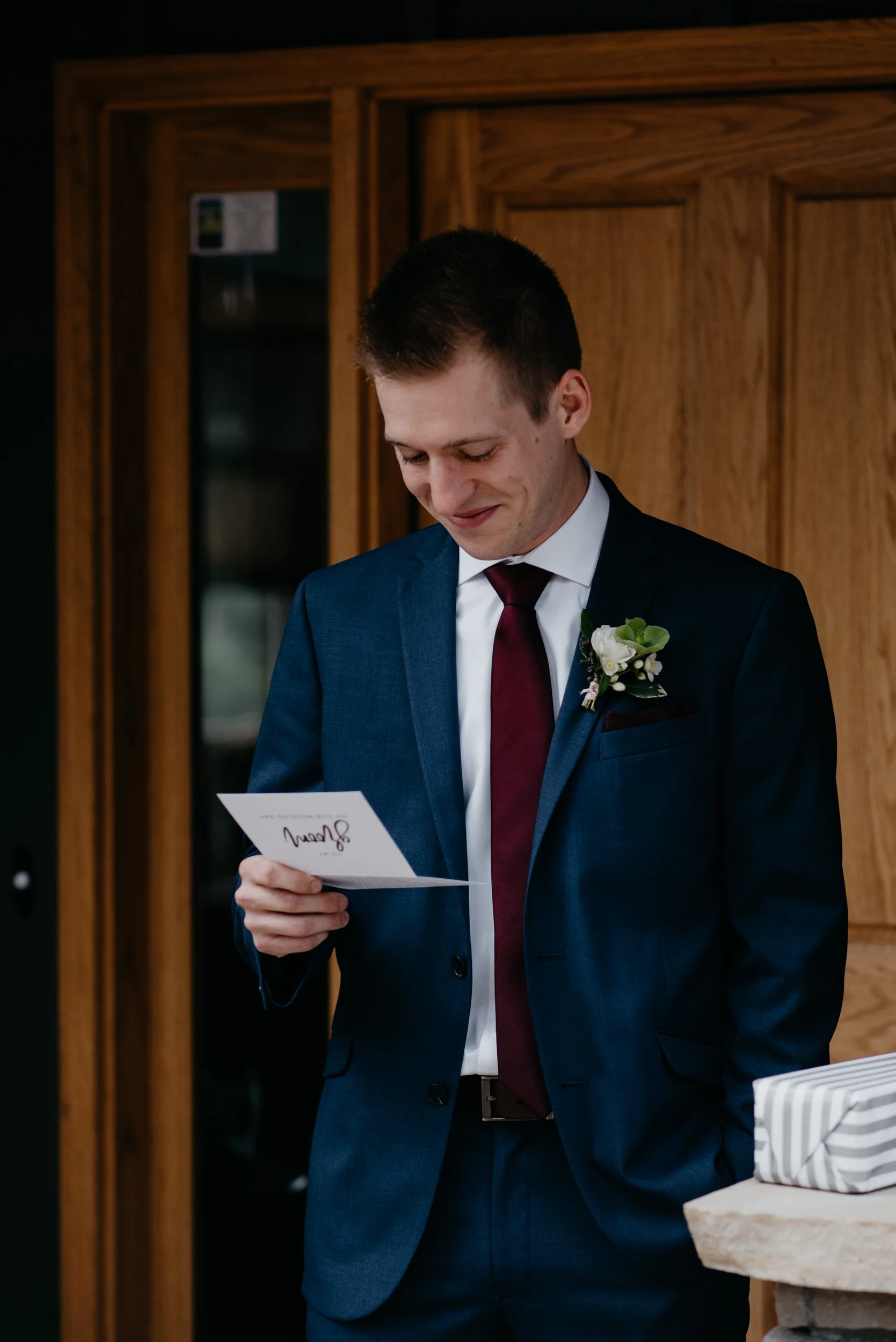  Groom opening gift from bride. 3M Curve, Rocky Mountain National Park elopement. 