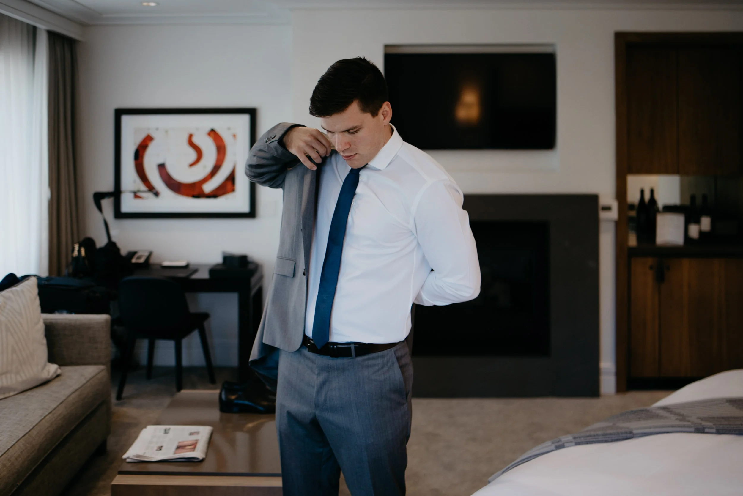  Groom getting ready before wedding at The Little Nell. Aspen, CO wedding photographer. 