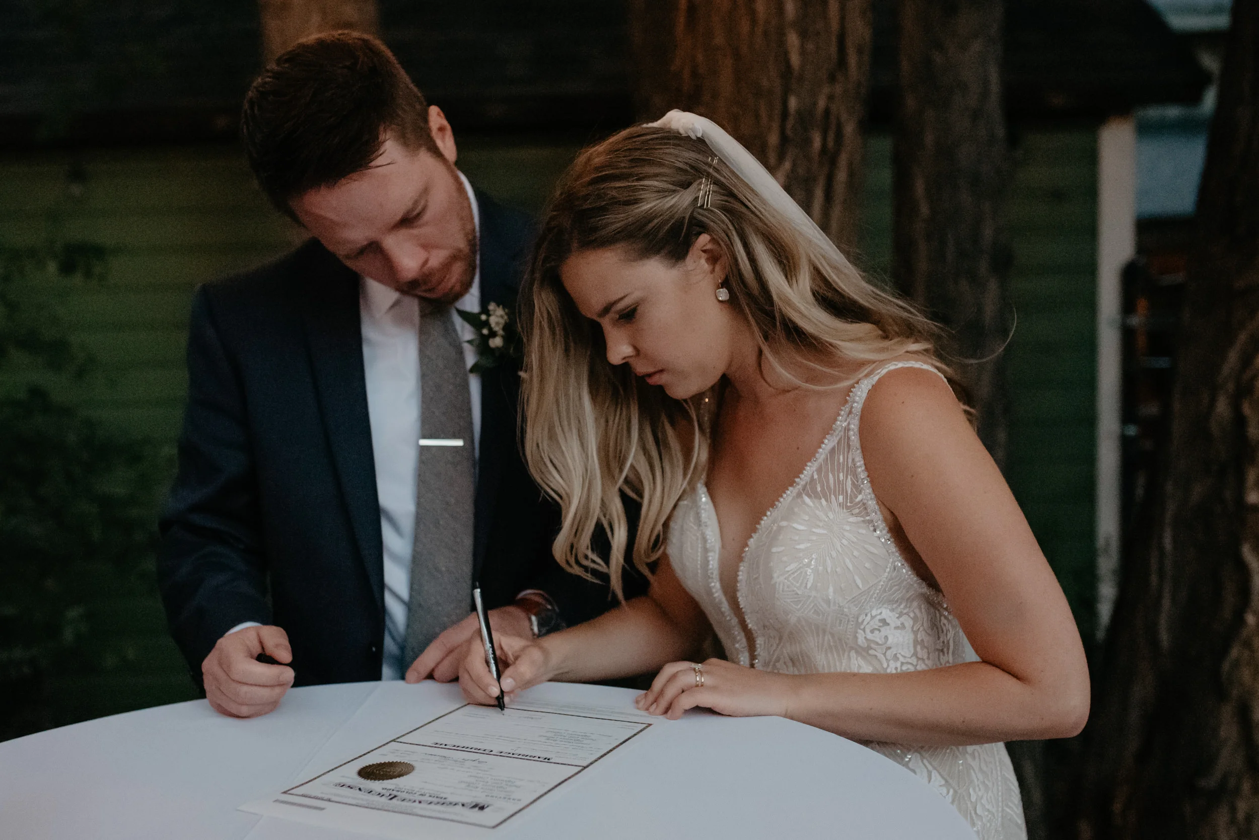  Bride and groom signing marriage license at Three Leaf Farm wedding. Boulder, Colorado wedding and elopement photographer. Colorado affordable wedding photography. 