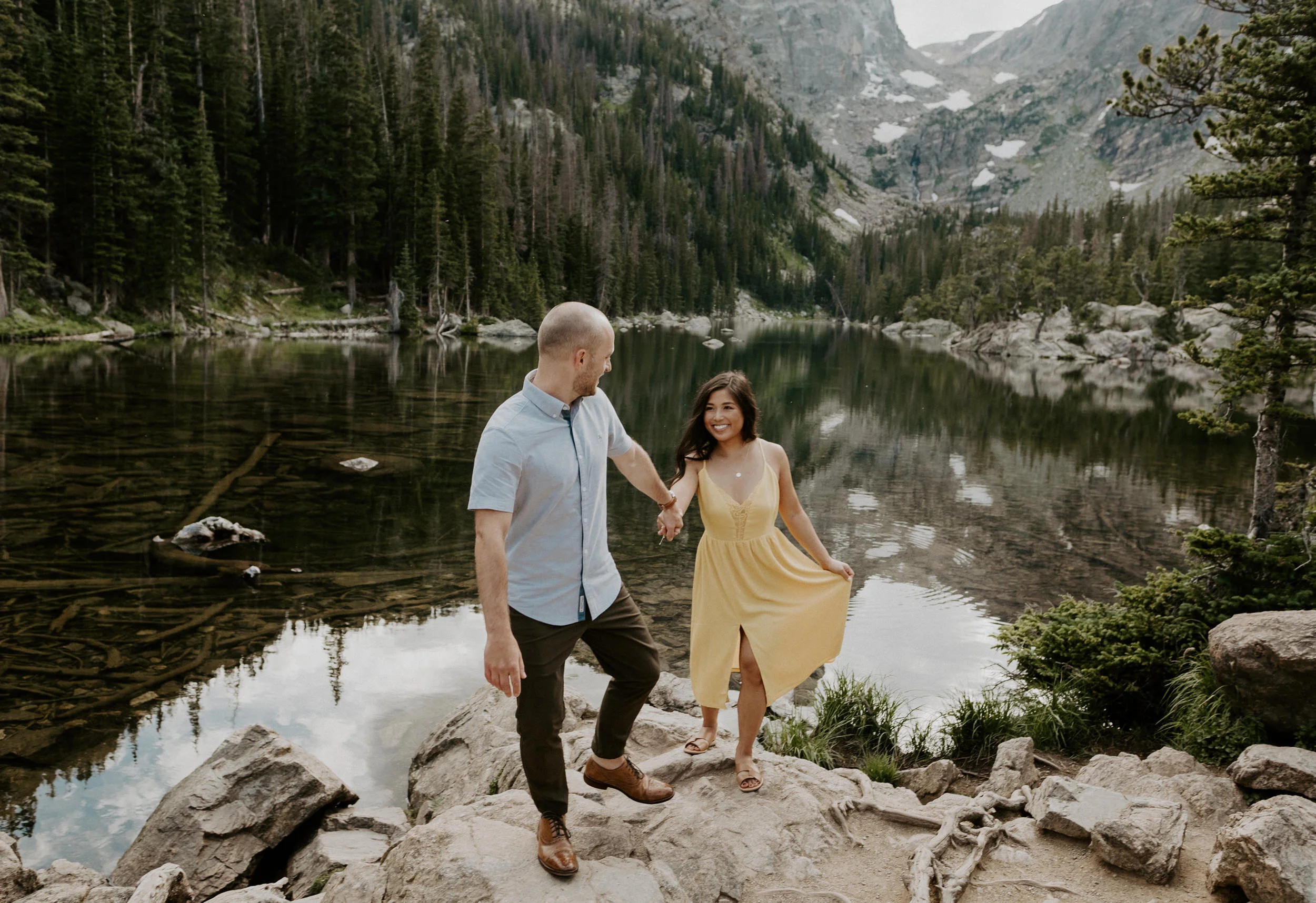  Rocky Mountain National Park hiking engagement session at Dream Lake. Engagement Session outfit ideas. Dream Lake engagement session in Estes Park, Colorado. Estes Park engagement session location ideas. Colorado wedding photographer. Estes Park elopement photographer. Rocky Mountain National Park engagement photos. Colorado adventure engagement photography. 