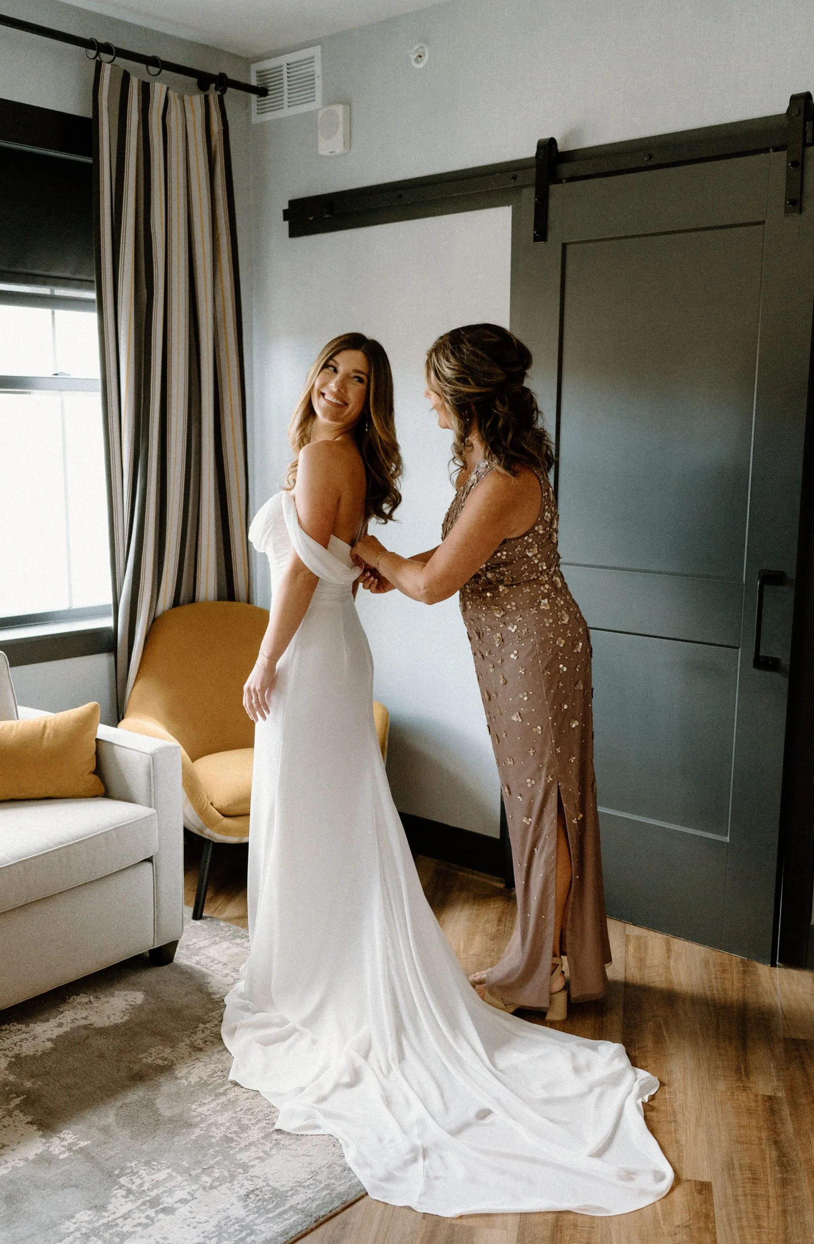 Brides' mom zipping up her wedding dress at The Eddy in Golden Colorado