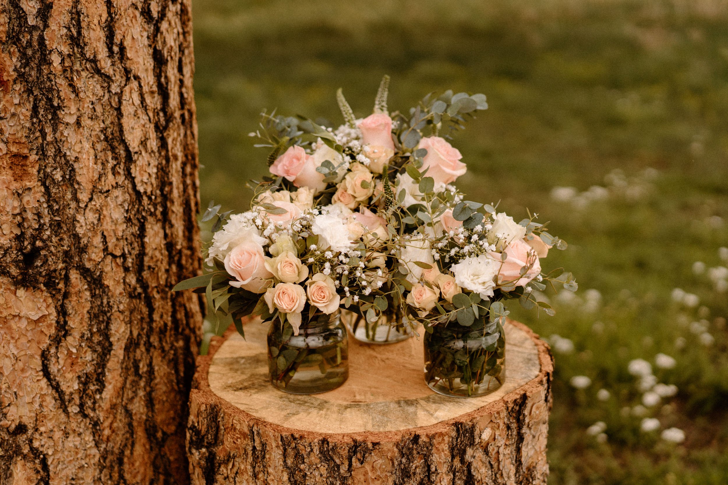 Pink and white flower bouquets sit atop the altar
