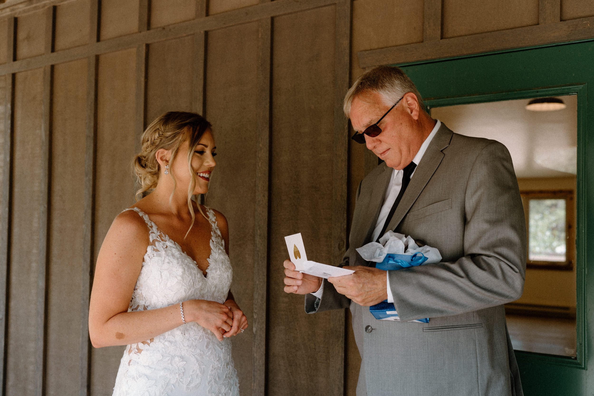 Bride watches as father opens a gift from her