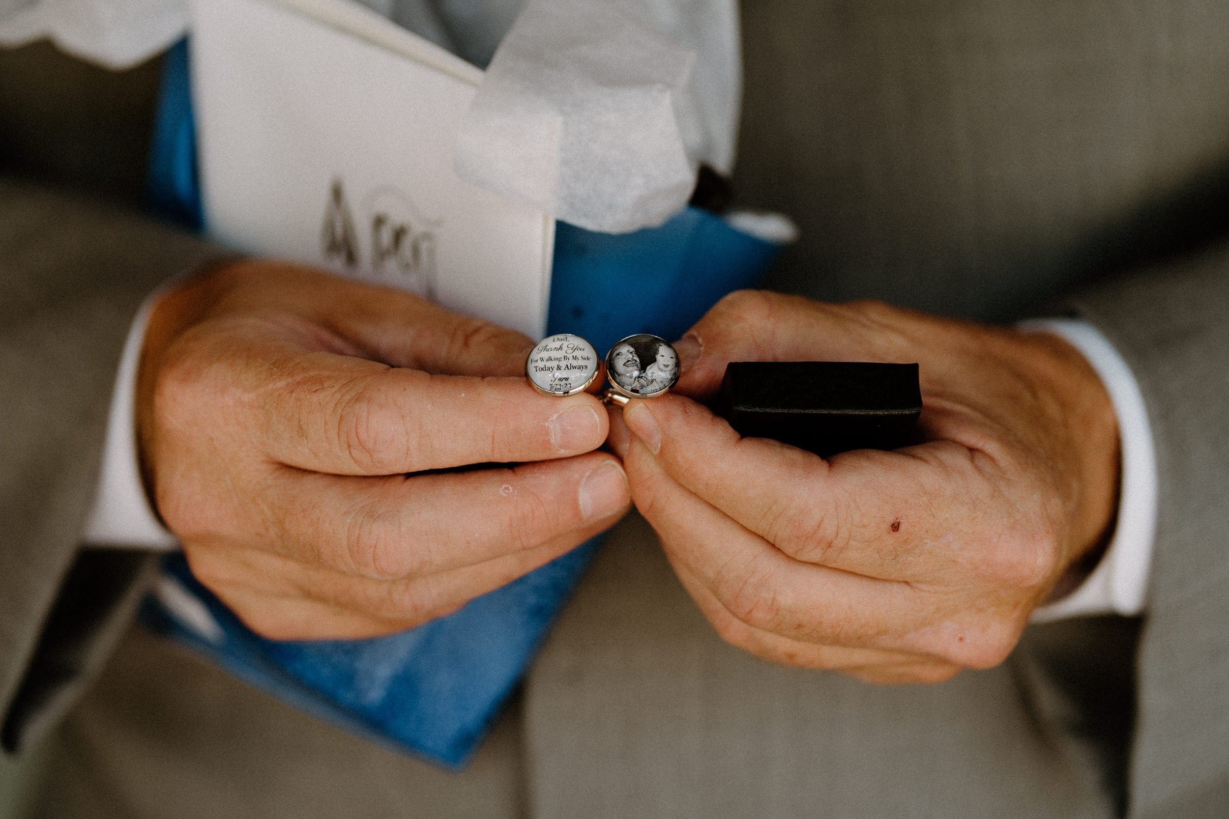 Father shows off cufflinks with a photo and inscription