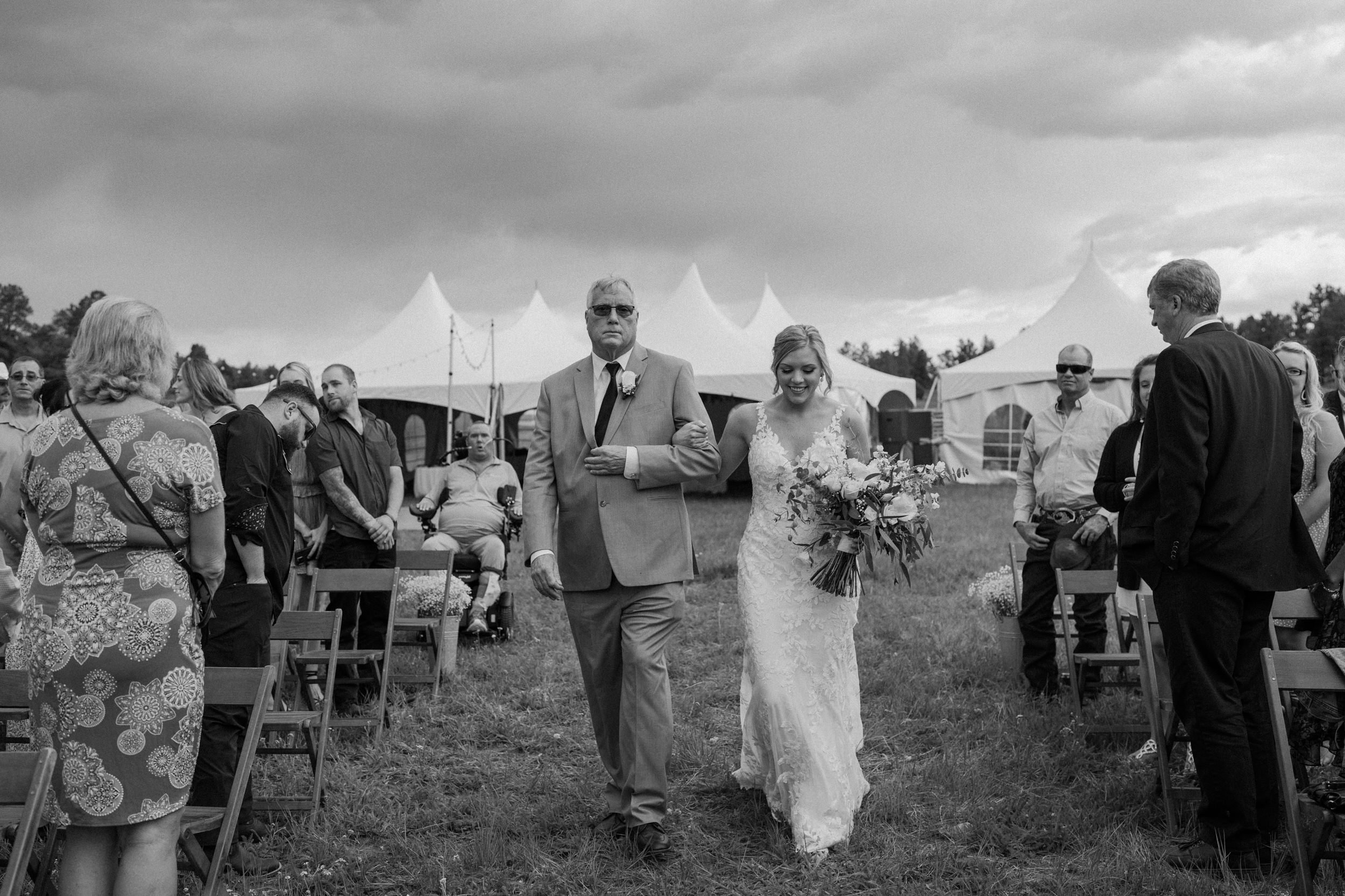 Bride and her father walk down the aisle together