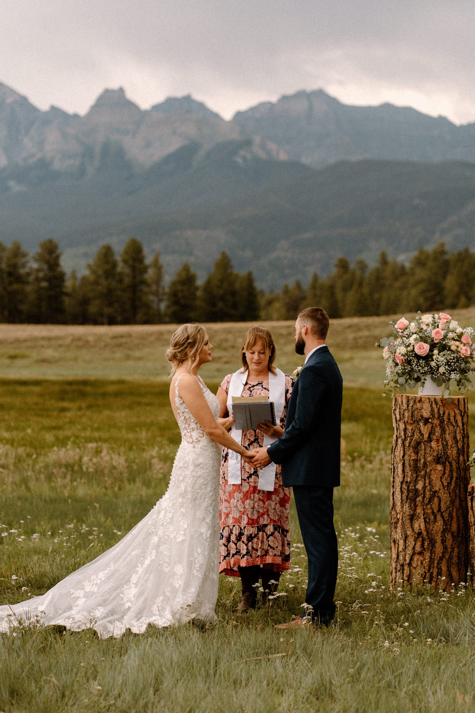 Bride and groom hold hands together at Top of the Pines in Ridgway, CO