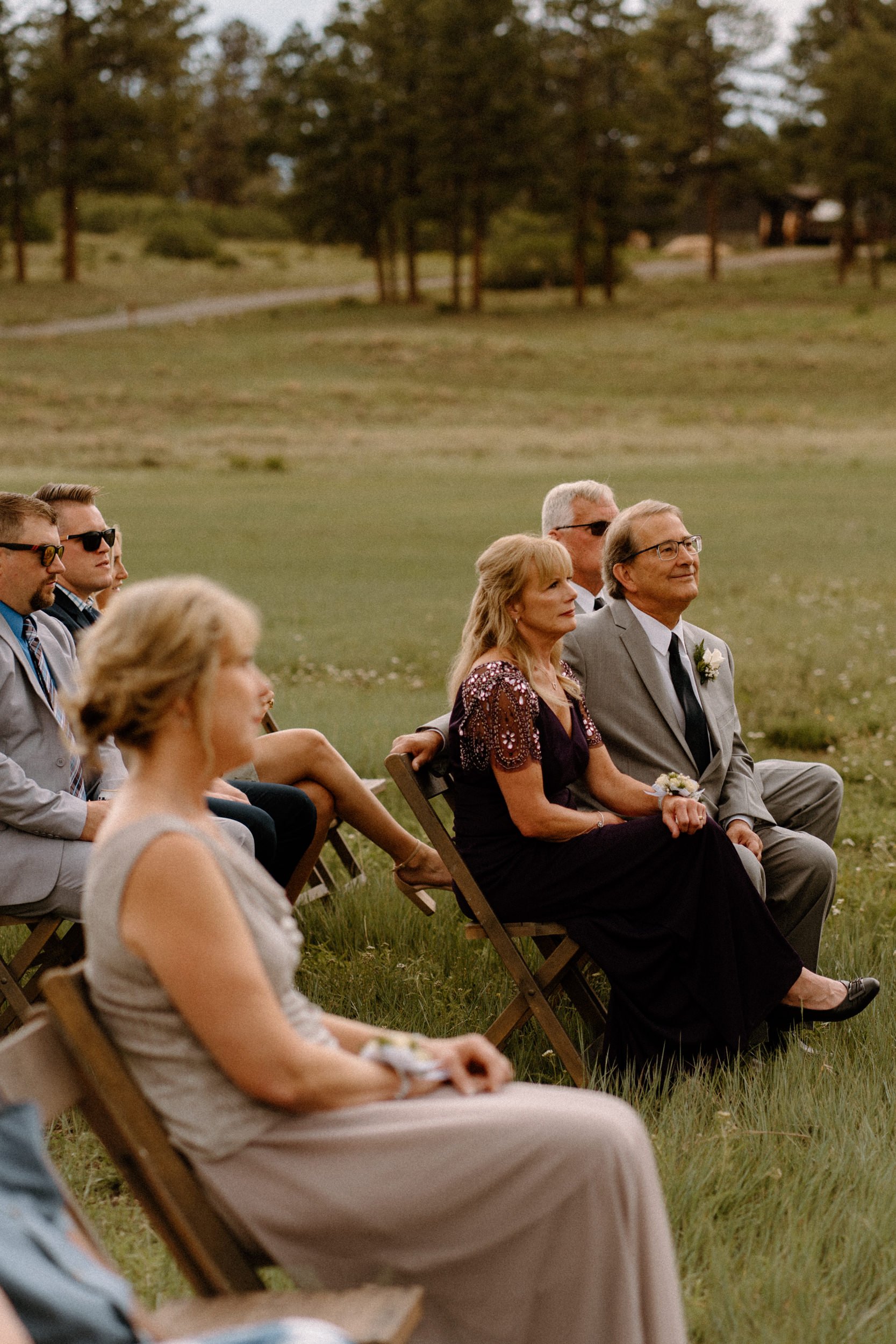 Guests look on as the wedding ceremony proceeds