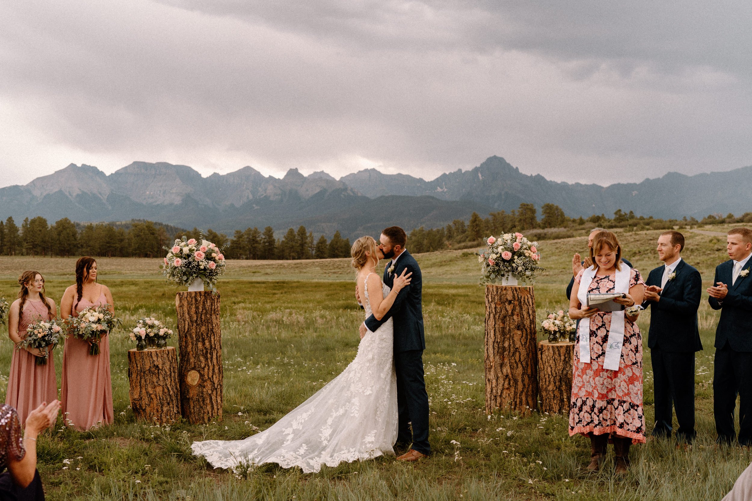 Bride and groom share their first kiss at Top of the Pines in Ridgway, CO
