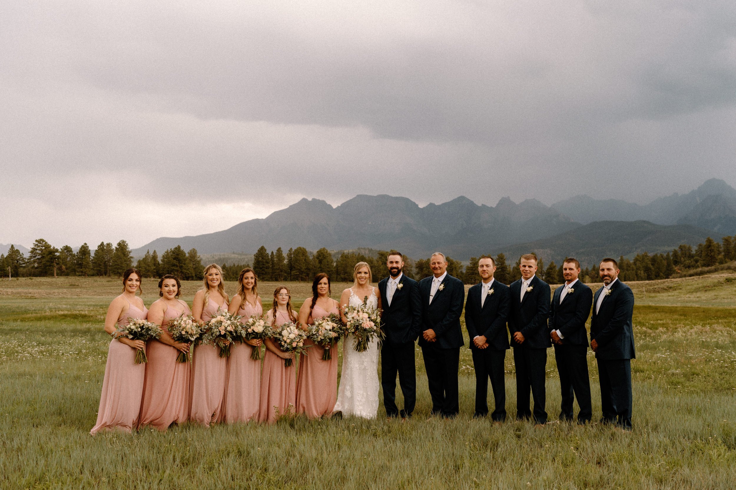 The wedding party poses with the bride and groom at Top of the Pines in Ridgway, CO