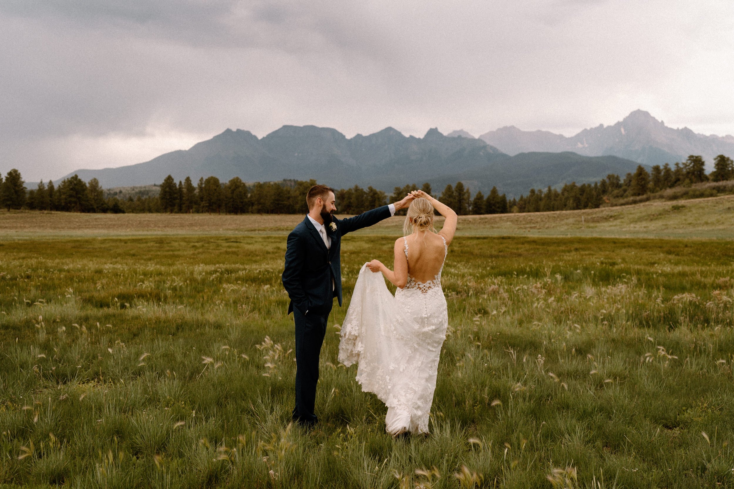 Groom twirls the bride around at Top of the Pines in Ridgway, CO
