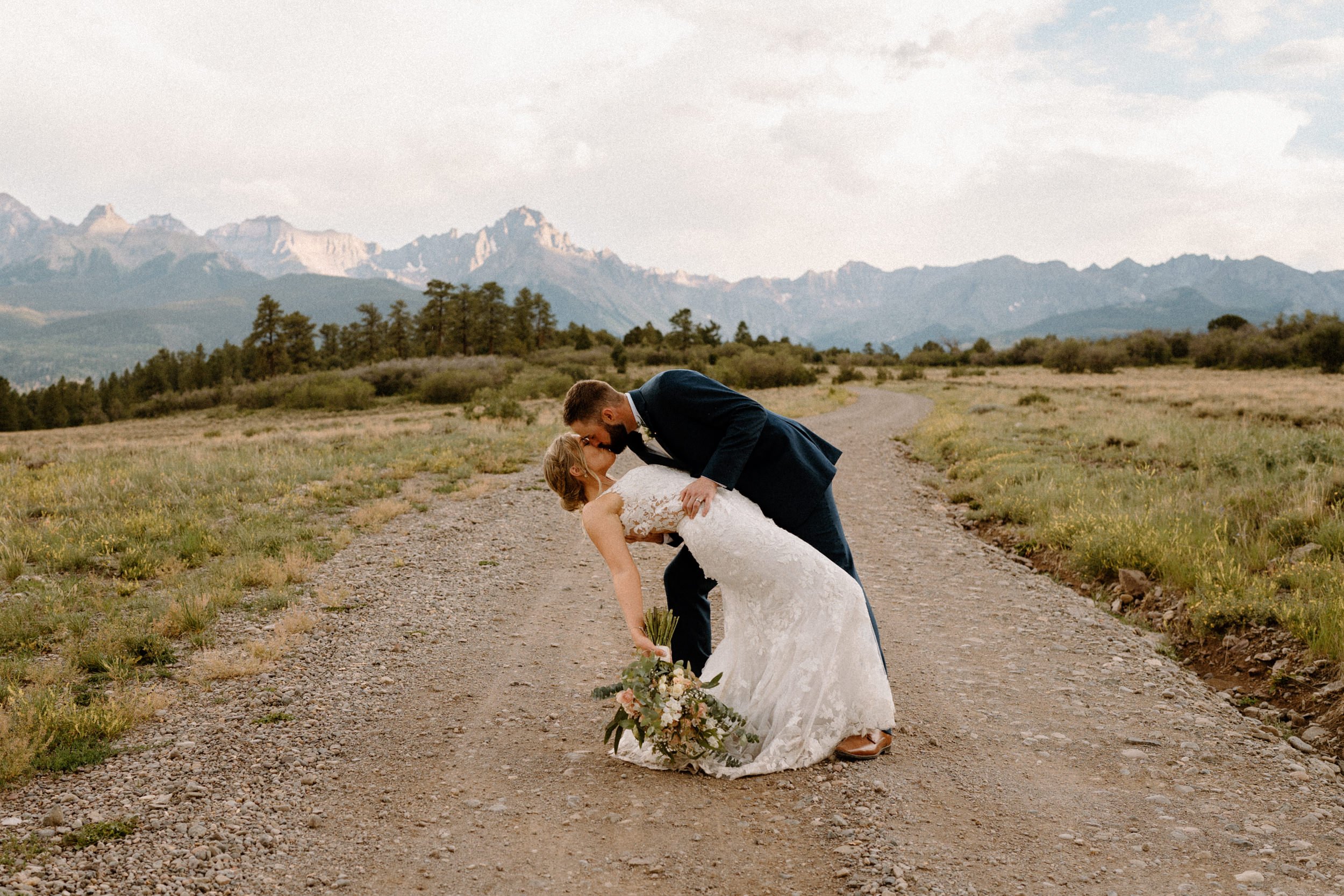 Groom dips the bride for a kiss at Top of the Pines in Ridgway, CO