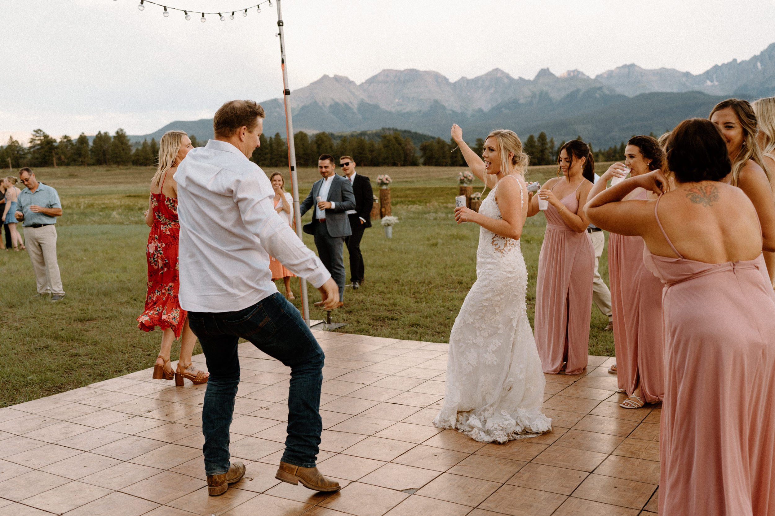 Bride dances with guests on the dance floor