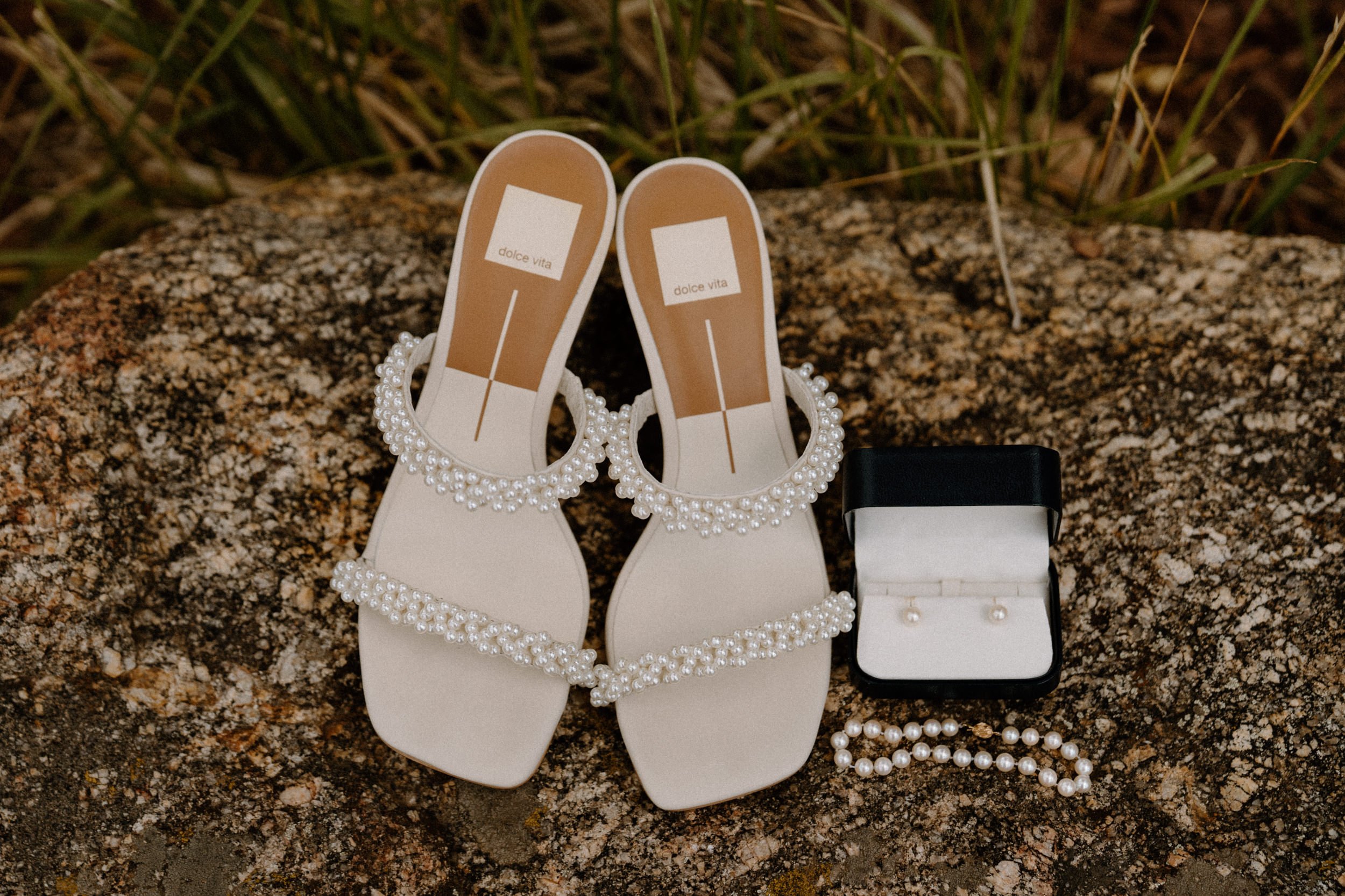 A close up of the bride's heels, bracelet and earrings