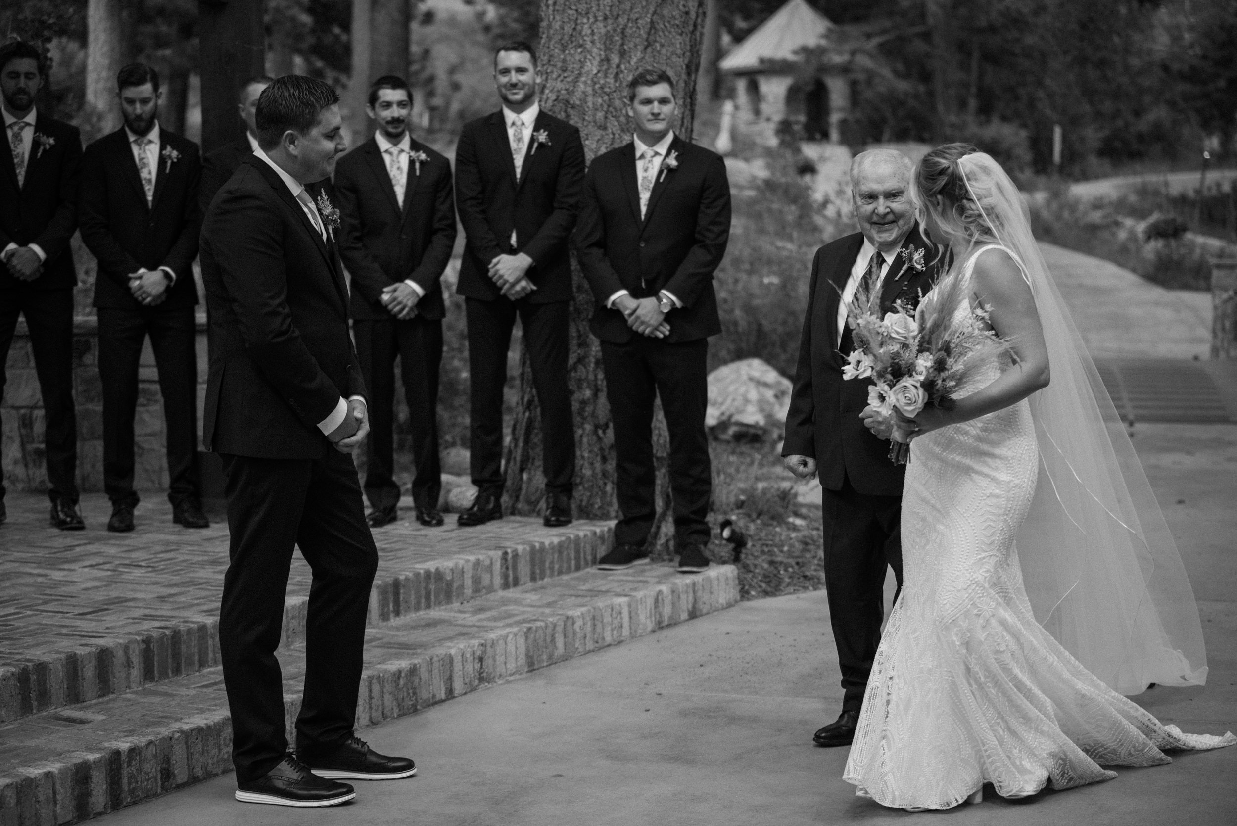 The father of the bride gives her away at the altar