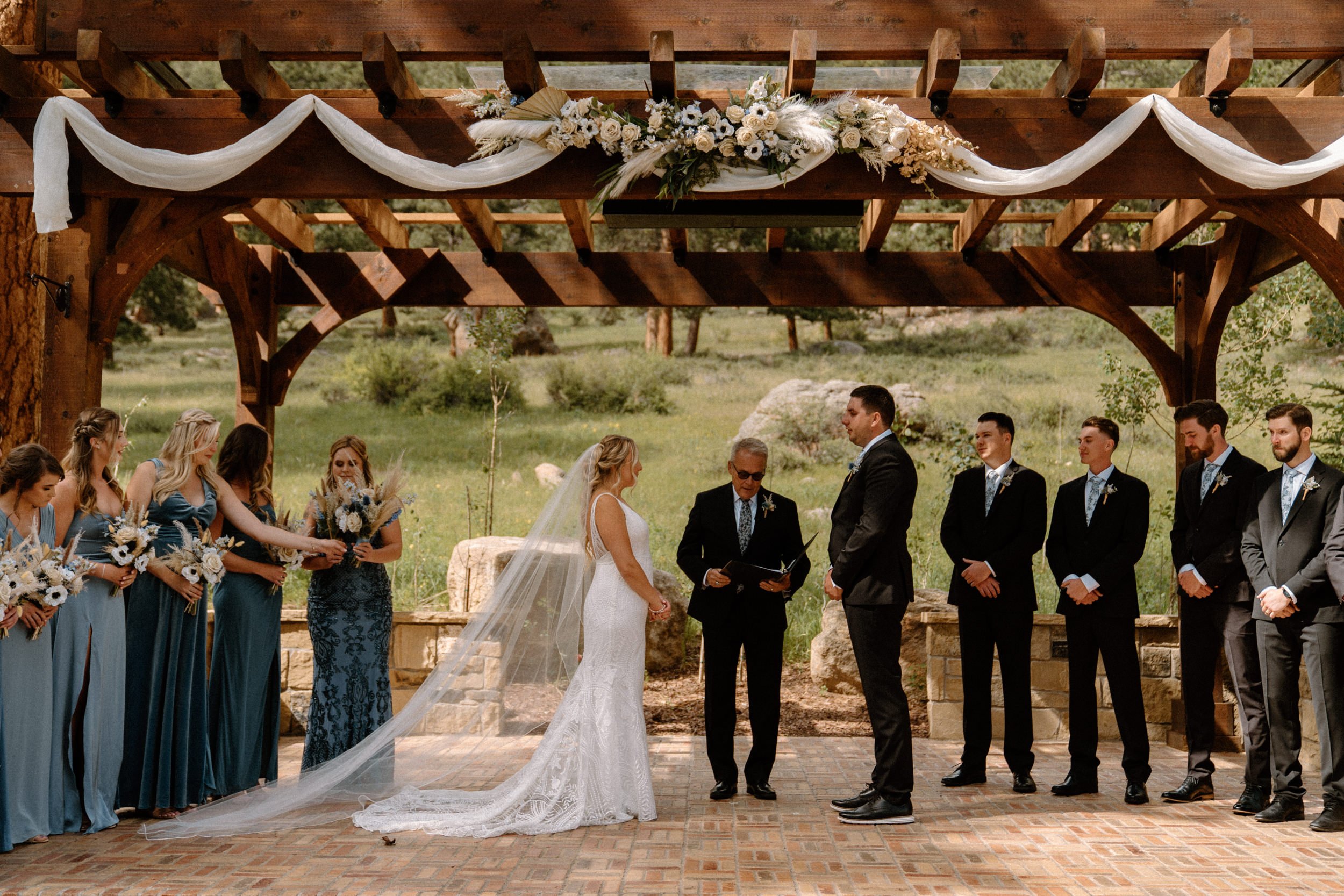 The bride and groom stand at the altar together at Della Terra Mountain Chateau in Estes Park, CO