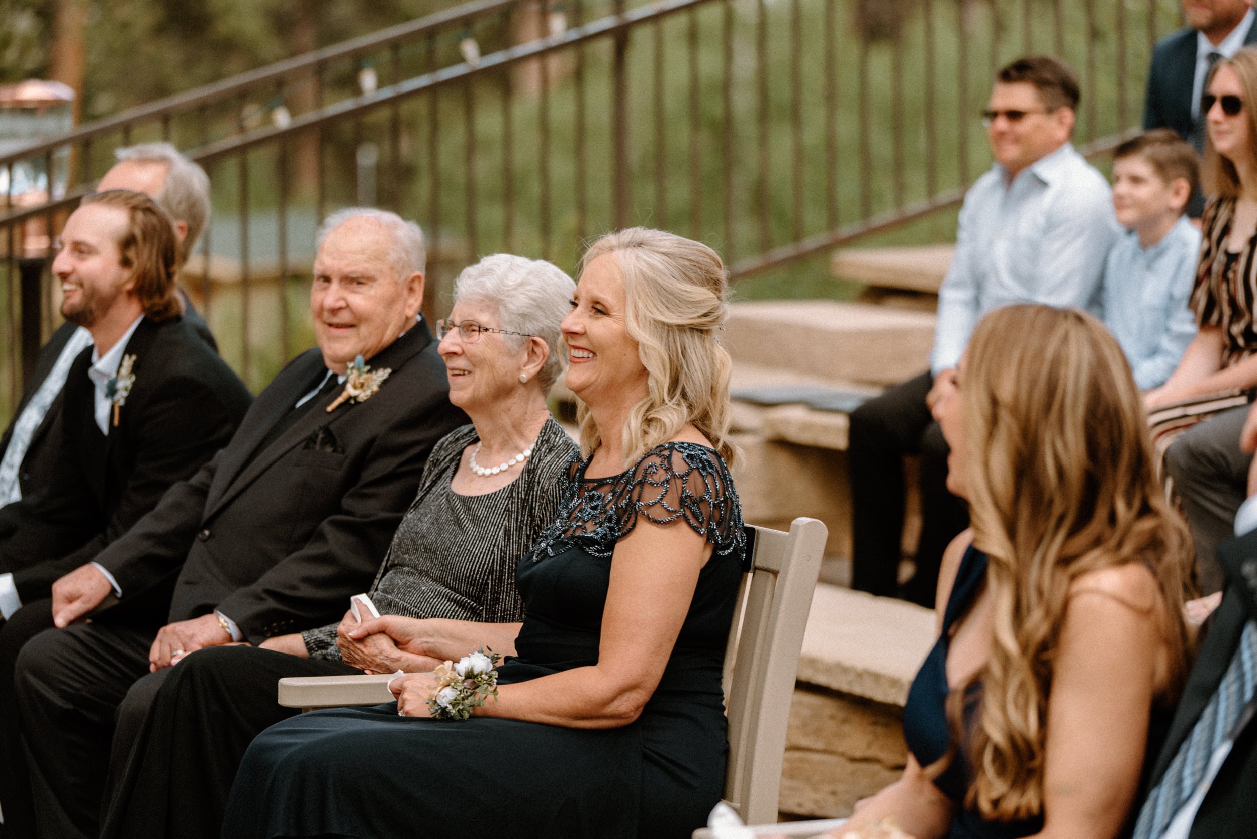 Wedding guests smile as the ceremony takes place