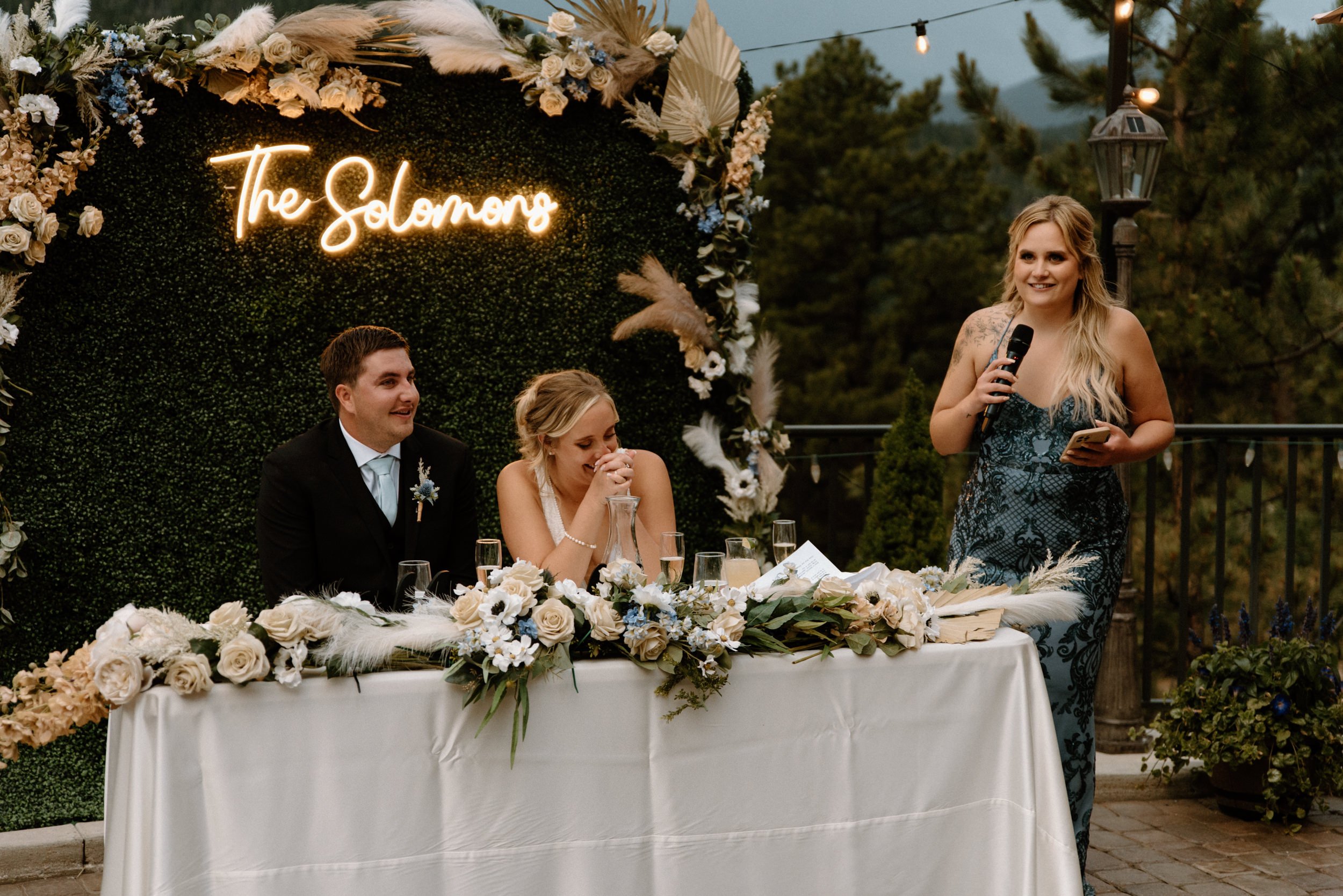 A bridesmaid gives a toast to the couple as they laugh